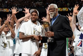 SAN ANTONIO, TX - JUNE 15: Bill Russell presents the Bill Russell MVP Trophy to Kawhi Leonard #2 of the San Antonio Spurs after the San Antonio Spurs victory in Game Five and winning the 2014 NBA Finals against the Miami Heat at AT&T Center on June 15, 20