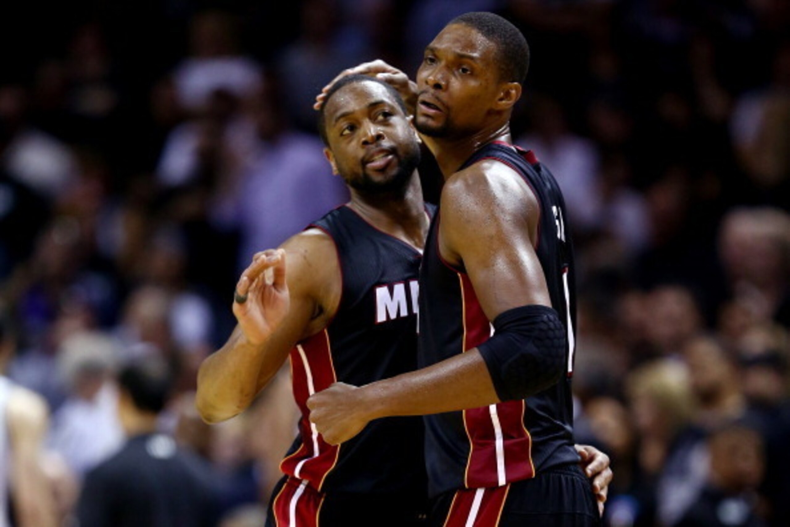 SAN ANTONIO, TX - JUNE 08:  Chris Bosh #1 of the Miami Heat celebrates with Dwyane Wade #3 against the San Antonio Spurs during Game Two of the 2014 NBA Finals at the AT&T Center on June 8, 2014 in San Antonio, Texas. The Miami Heat defeated the San Anton