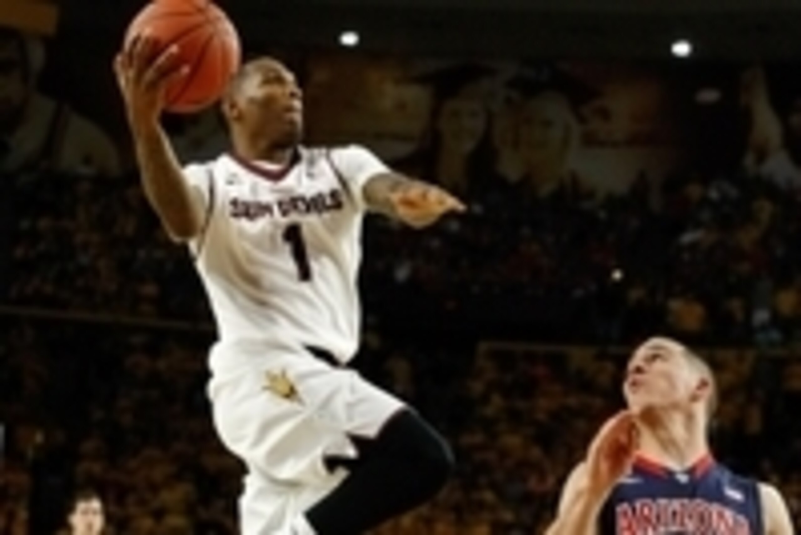 Feb 14, 2014; Tempe, AZ, USA; Arizona State Sun Devils guard Jahii Carson (1) drives past Arizona Wildcats guard T.J. McConnell (4) during the second half at Wells Fargo Arena. The Sun Devils defeated the Wildcats 69-66 in double overtime. Mandatory Credi