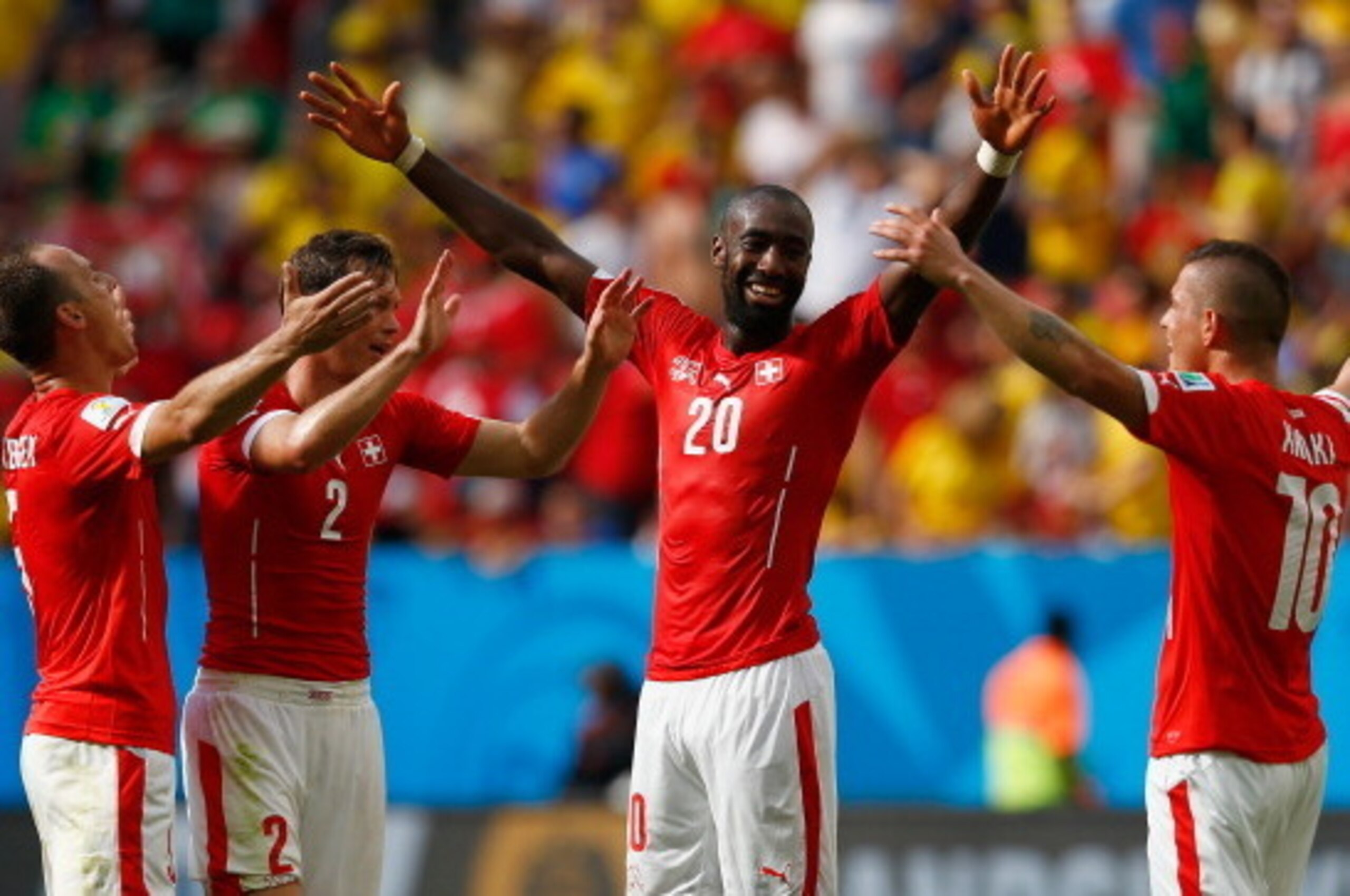 BRASILIA, BRAZIL - JUNE 15:  Johan Djourou of Switzerland (2nd R) celebrates with Steve von Bergen (L), Stephan Lichtsteiner (2nd L) and Granit Xhaka after defeating Ecuador 2-1 in the 2014 FIFA World Cup Brazil Group E match between Switzerland and Ecuad
