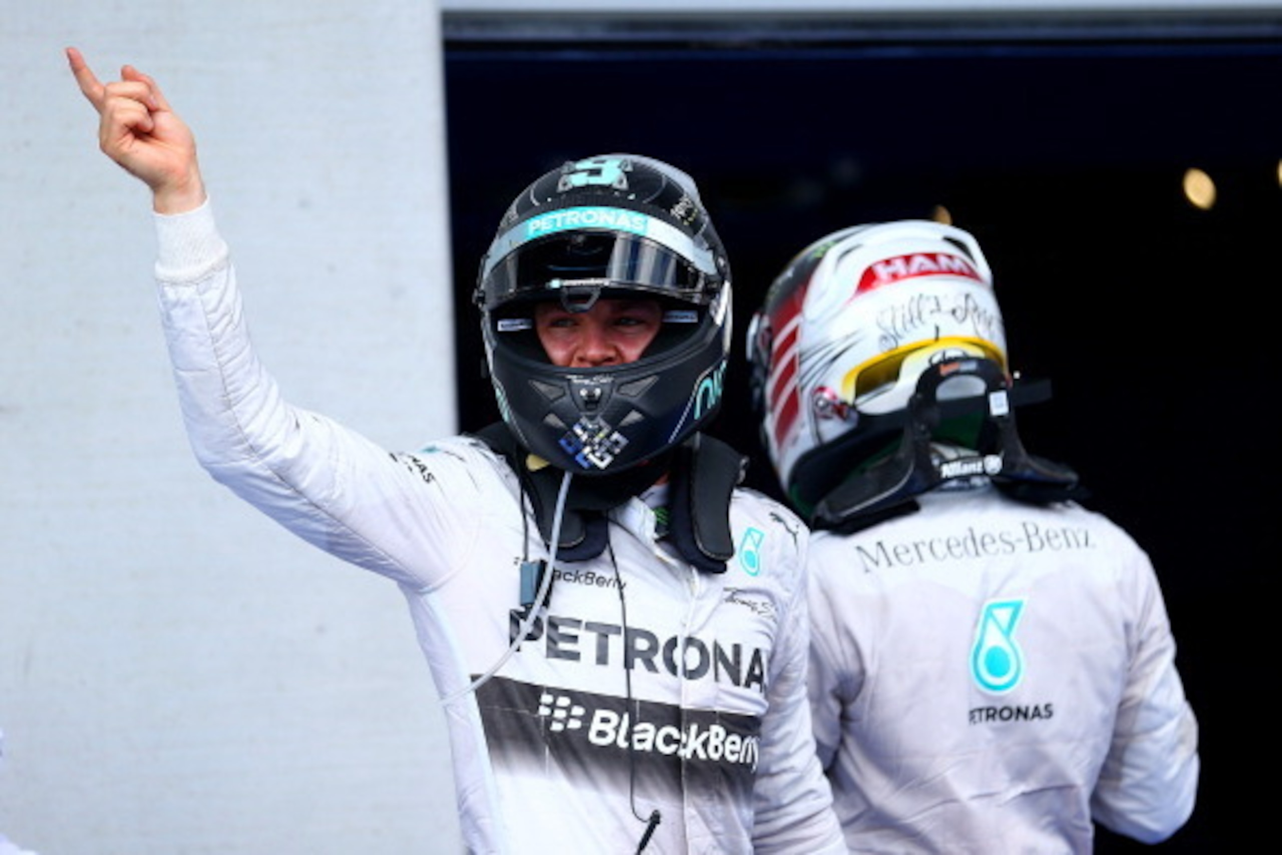 SPIELBERG, AUSTRIA - JUNE 22:  Nico Rosberg of Germany and Mercedes GP celebrates victory next to Lewis Hamilton of Great Britain and Mercedes GP after the Austrian Formula One Grand Prix at Red Bull Ring on June 22, 2014 in Spielberg, Austria.  (Photo by