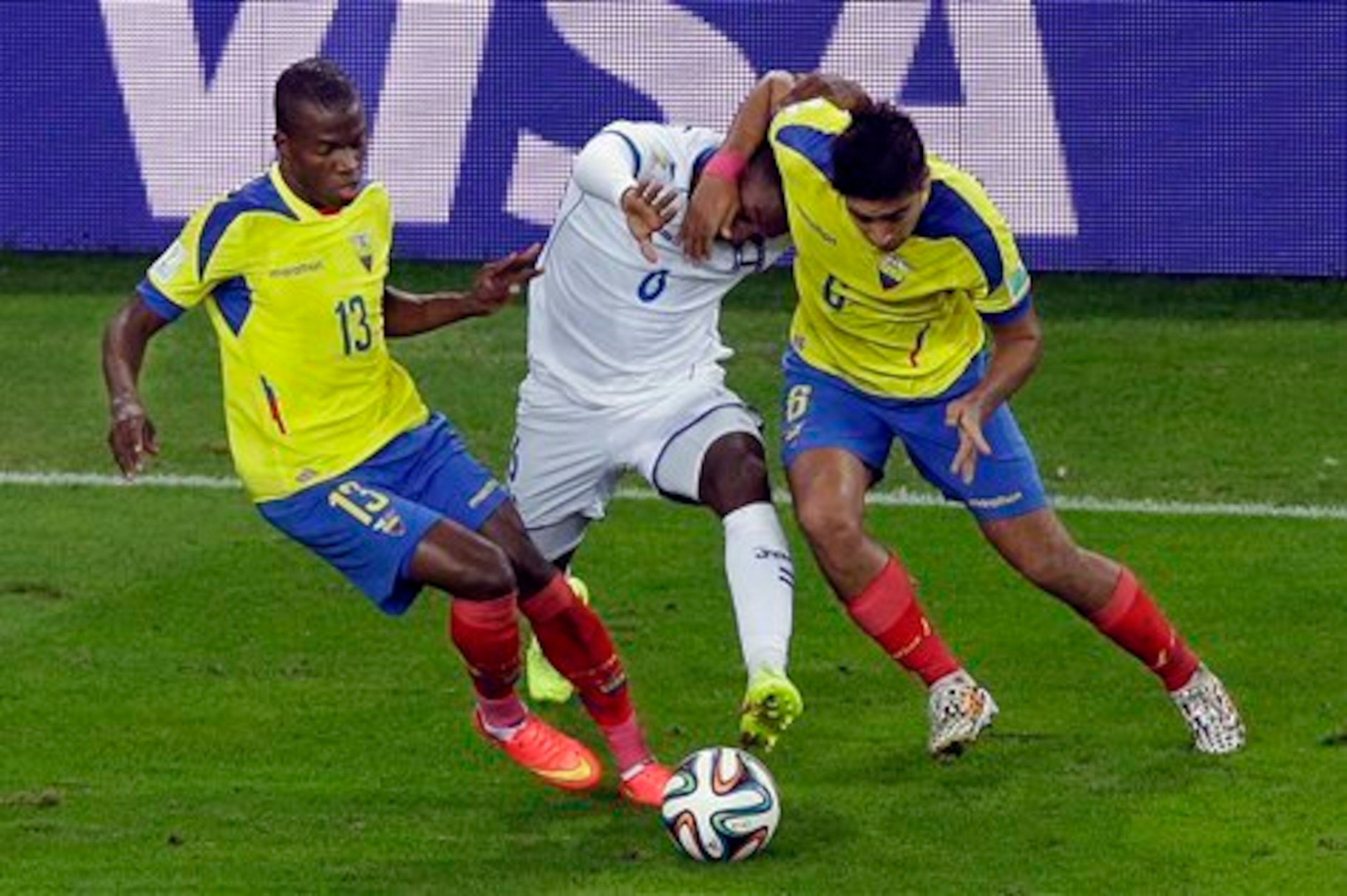 Cristhian Noboa (R) battles for possession against Honduras.