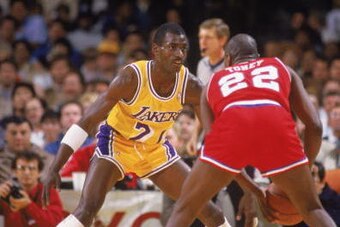 LOS ANGELES - 1987:  Michael Cooper #21 of the Los Angeles Lakers guards Andrew Toney #22 of the Philadelphia 76ers during an NBA game at the Great Western Forum in Los Angeles, California in 1987. (Photo by: Mike Powell/Getty Images)