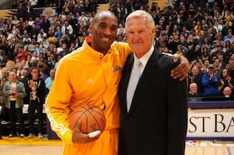 LOS ANGELES - FEBRUARY 3:  Kobe Bryant #24 of the Los Angeles Lakers is presented with the game ball by former Laker Jerry West  (L) before a game against the Charlotte Bobcats at Staples Center on February 3, 2010 in Los Angeles, California.  Bryant brok