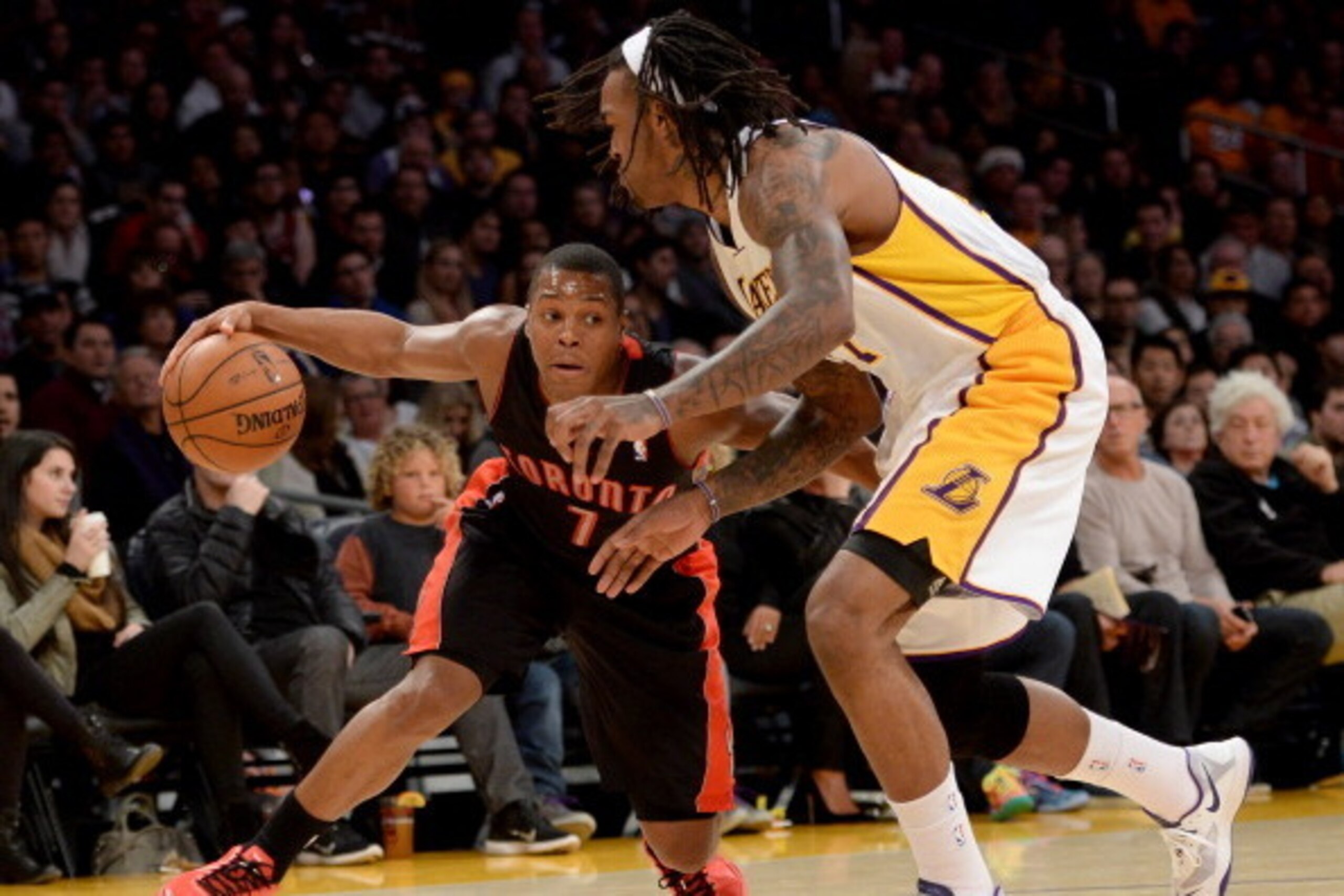 LOS ANGELES, CA - DECEMBER 08:  Kyle Lowry #7 of the Toronto Raptors drives on Jordan Hill #27 of the Los Angeles Lakers at Staples Center on December 8, 2013 in Los Angeles, California.  NOTE TO USER: User expressly acknowledges and agrees that, by downl
