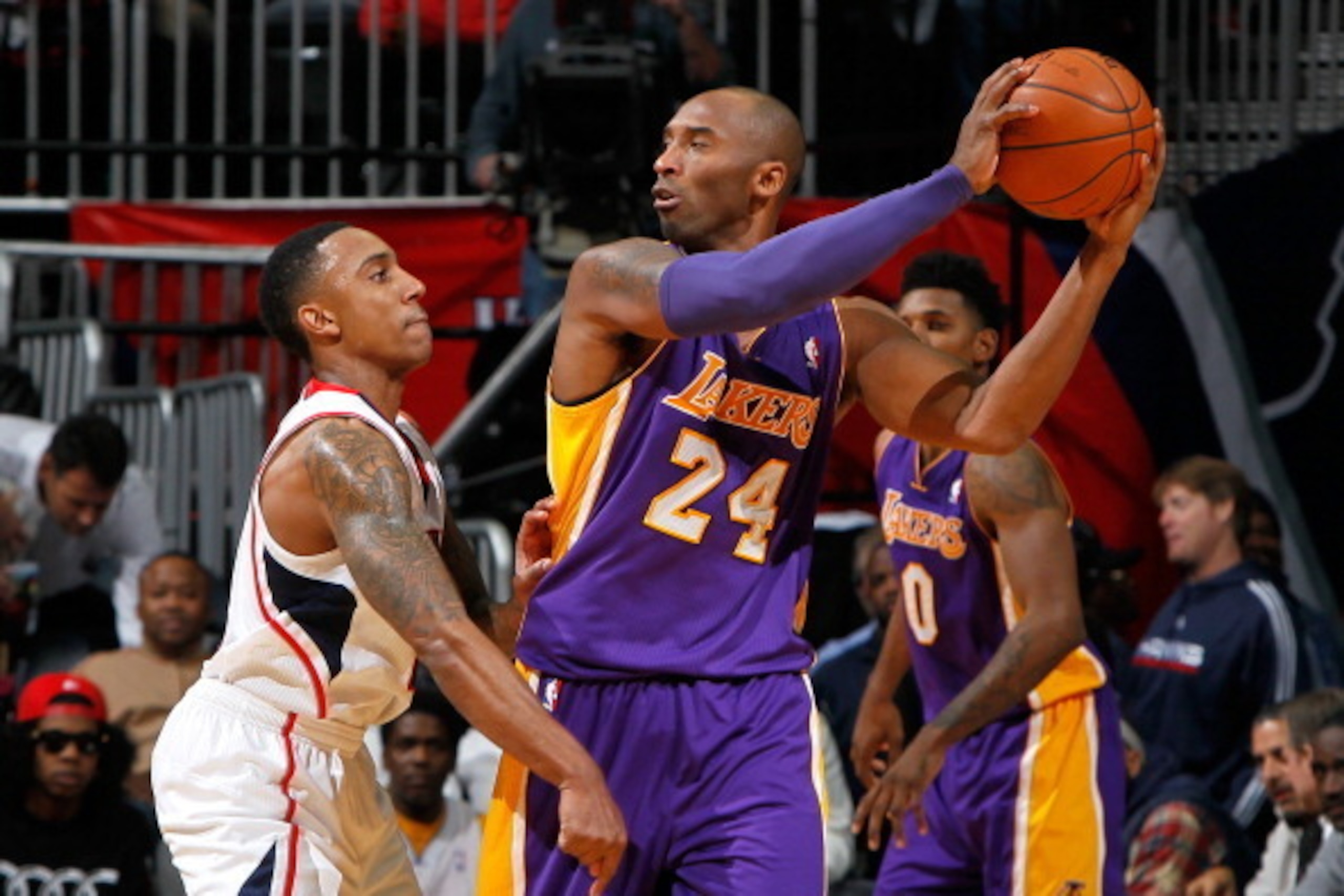 ATLANTA, GA - DECEMBER 16:  Jeff Teague #0 of the Atlanta Hawks defends against Kobe Bryant #24 of the Los Angeles Lakers at Philips Arena on December 16, 2013 in Atlanta, Georgia.  NOTE TO USER: User expressly acknowledges and agrees that, by downloading