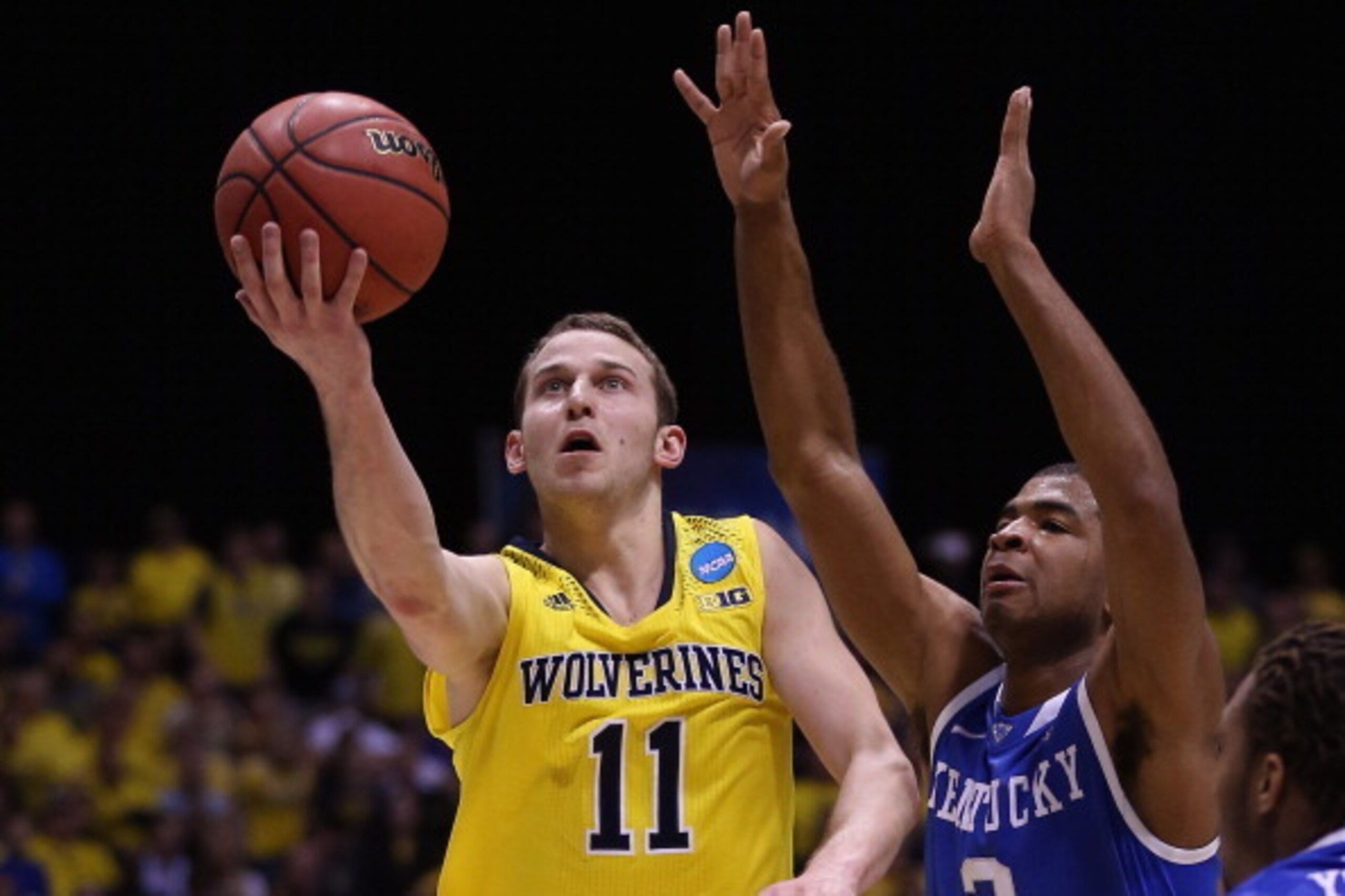 INDIANAPOLIS, IN - MARCH 30:  Nik Stauskas #11 of the Michigan Wolverines shoots the ball against Aaron Harrison #2 of the Kentucky Wildcats during the midwest regional final of the 2014 NCAA Men's Basketball Tournament at Lucas Oil Stadium on March 30, 2