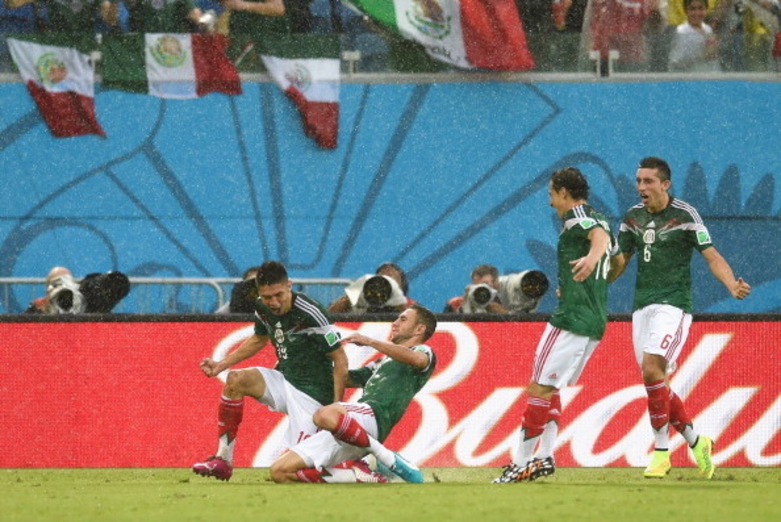 NATAL, BRAZIL - JUNE 13:  Oribe Peralta of Mexico (L) celebrates his goal with teammates in the second half during the 2014 FIFA World Cup Brazil Group A match between Mexico and Cameroon at Estadio das Dunas on June 13, 2014 in Natal, Brazil.  (Photo by 