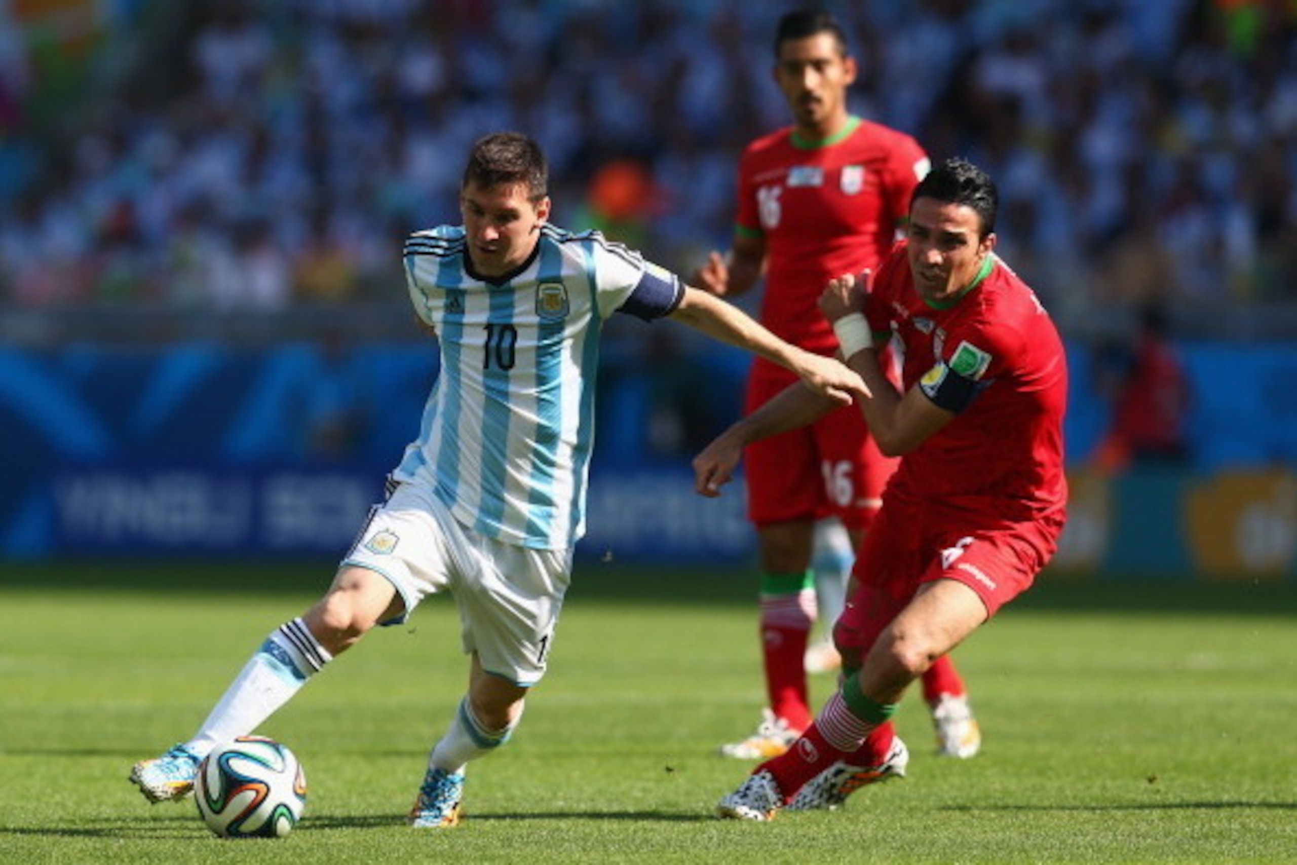 BELO HORIZONTE, BRAZIL - JUNE 21:  Lionel Messi of Argentina controls the ball as Javad Nekounam of Iran gives chase during the 2014 FIFA World Cup Brazil Group F match between Argentina and Iran at Estadio Mineirao on June 21, 2014 in Belo Horizonte, Bra