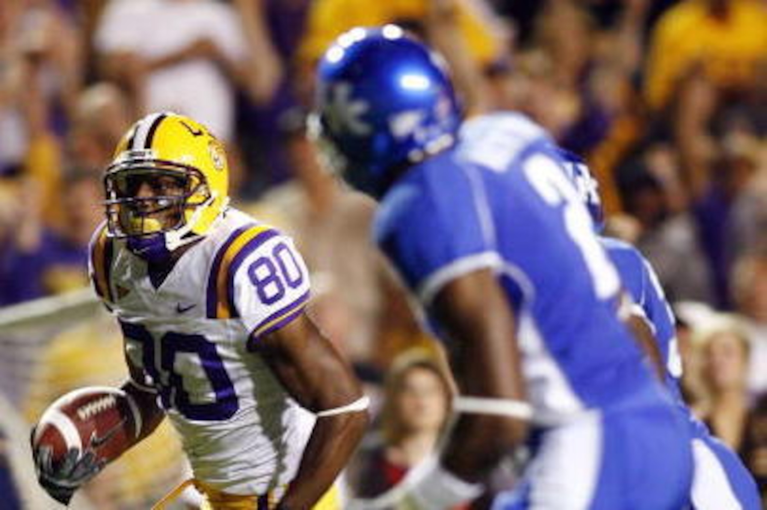 BATON ROUGE, LA - OCTOBER 14: Dwayne Bowe #80 of Louisiana State University runs for a touchdown past Marcus McClinton #2 of Kentucky University on October 14, 2006 at Tiger Stadium in Baton Rouge, Louisiana.    (Photo by Chris Graythen/Getty Images)