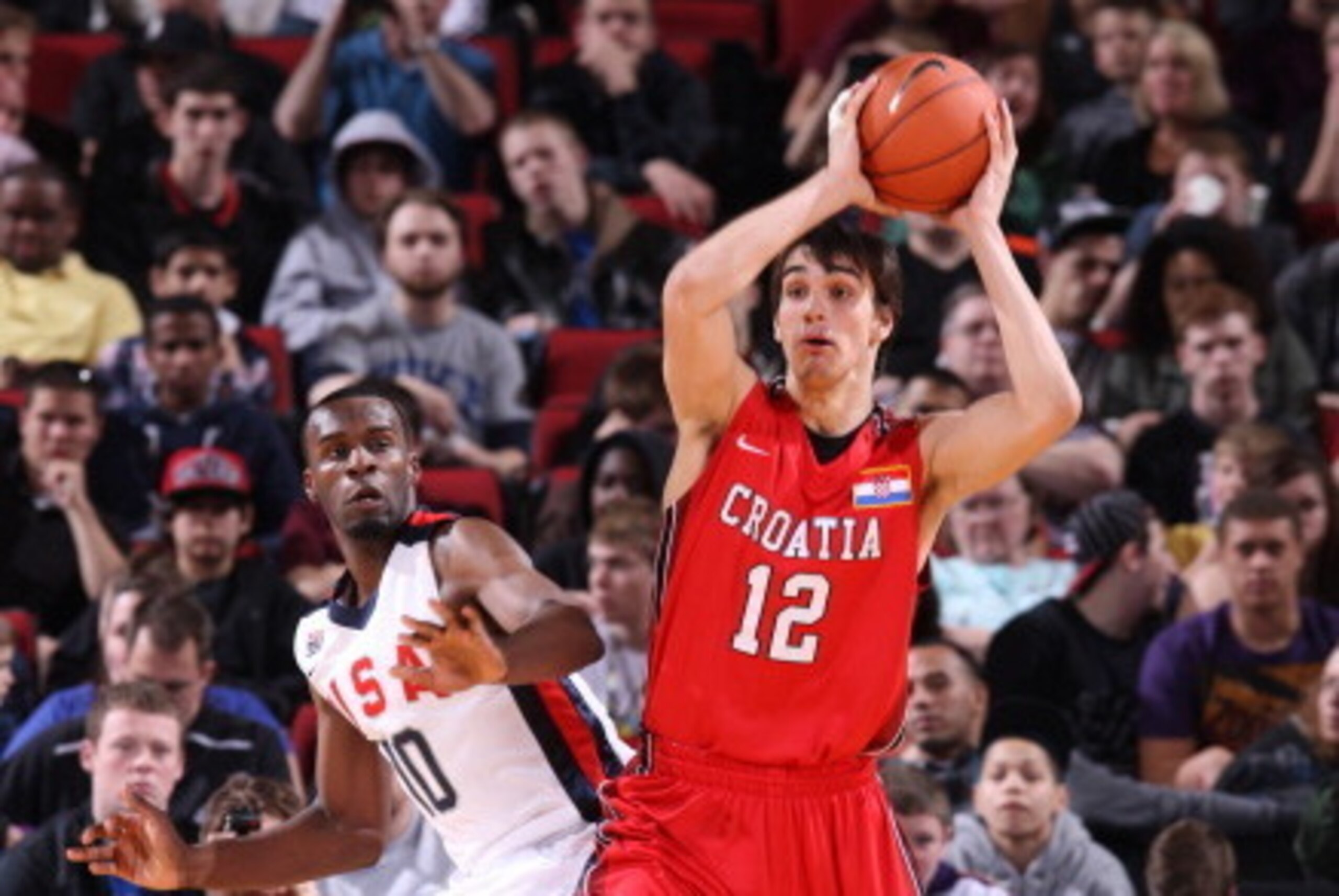 PORTLAND, OR - APRIL 7: Dario Saric #12 of the World Select Team passes against Shabazz Muhammad #10 of the USA Junior Select Team during the 2012 Hoop Summit on April 7, 2012 at the Rose Garden Arena in Portland, Oregon. NOTE TO USER: User expressly ackn PORTLAND, OR - APRIL 7: Dario Saric #12 of the World Select Team passes against Shabazz Muhammad #10 of the USA Junior Select Team during the 2012 Hoop Summit on April 7, 2012 at the Rose Garden Arena in Portland, Oregon. NOTE TO USER: User expressly ackn