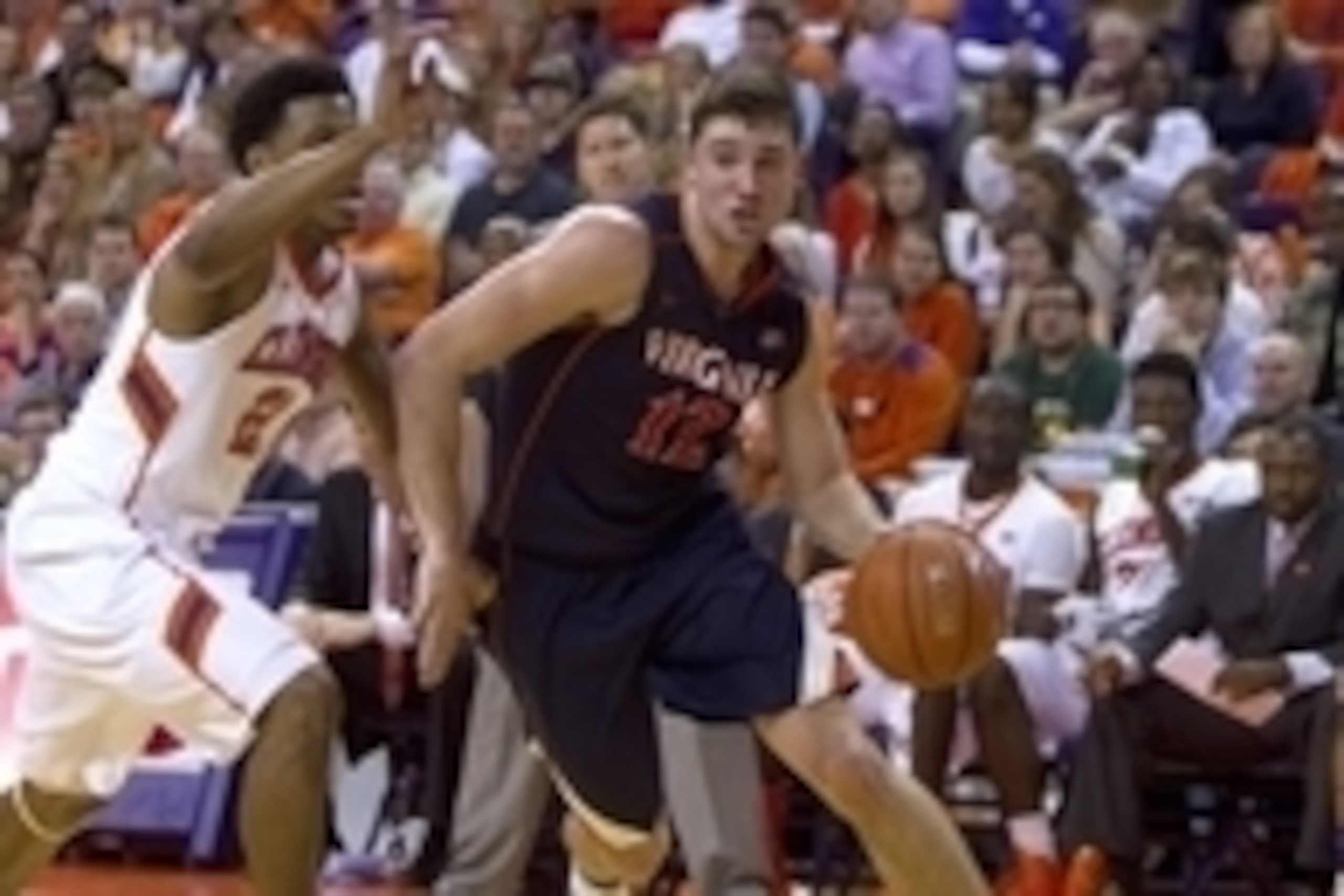 Feb 15, 2014; Clemson, SC, USA; Virginia Cavaliers guard Joe Harris (12) drives to the basket while being defended by Clemson Tigers guard Damarcus Harrison (21) during the first half at J.C. Littlejohn Coliseum. Mandatory Credit: Joshua S. Kelly-USA TODA