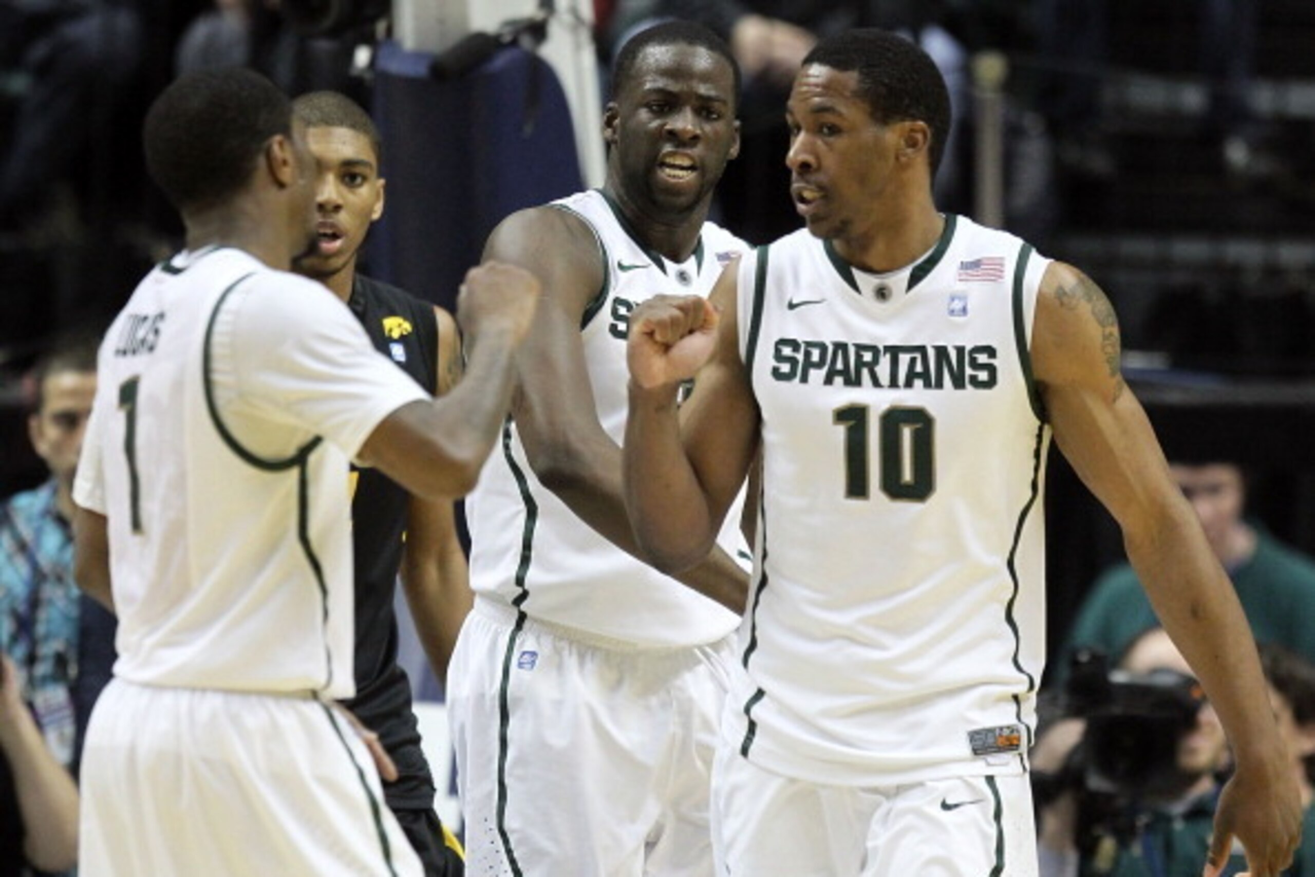 INDIANAPOLIS, IN - MARCH 10:  (L-R) Kalin Lucas #1 , Draymond Green #23 and Delvon Roe #10 of the Michigan State Spartans celebrate a play against the Iowa Hawkeyes during the first round of the 2011 Big Ten Men's Basketball Tournament at Conseco Fieldhou