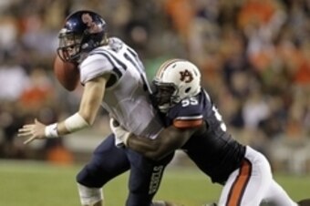 Oct 5, 2013; Auburn, AL, USA; Mississippi Rebels quarterback Bo Wallace (14) is tackled by Auburn Tigers defensive end Carl Lawson (55) during the first half at Jordan Hare Stadium. Mandatory Credit: John Reed-USA TODAY Sports