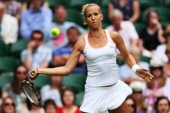 LONDON, ENGLAND - JUNE 23:  Paula Kania of Poland in action during her Ladies' Singles first round match against Na Li of China on day one of the Wimbledon Lawn Tennis Championships at the All England Lawn Tennis and Croquet Club at Wimbledon on June 23, 