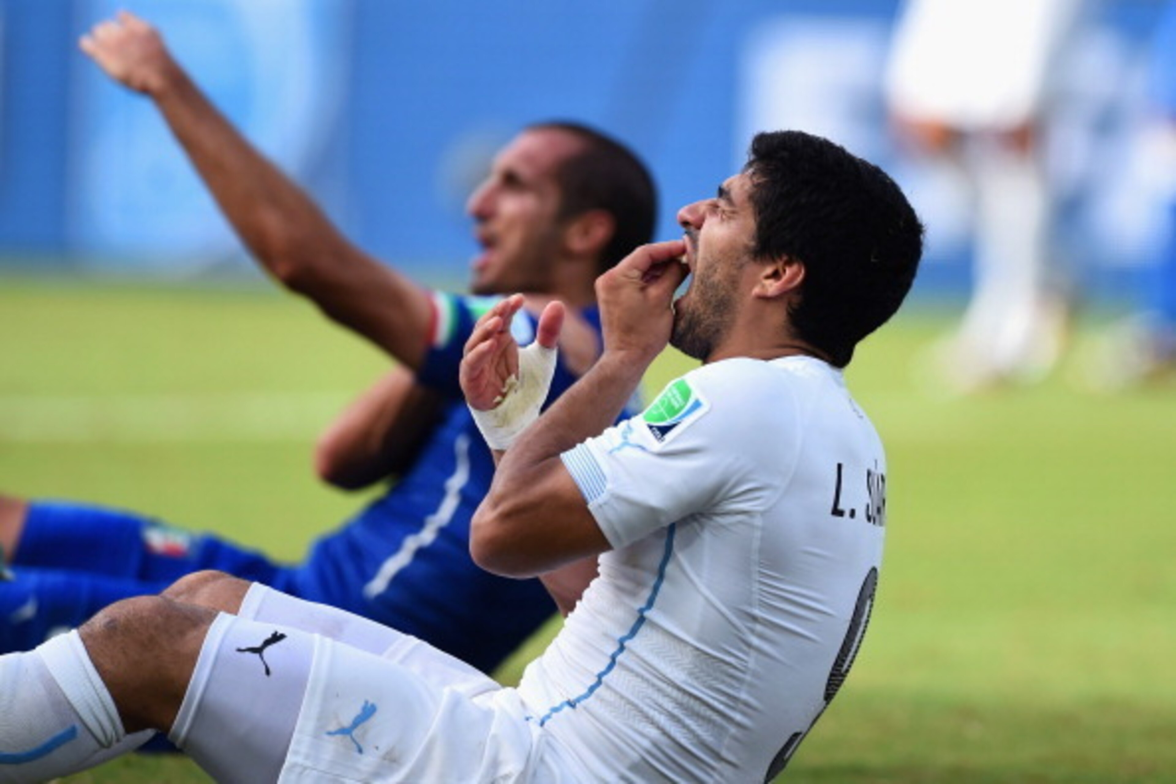 NATAL, BRAZIL - JUNE 24:  Luis Suarez of Uruguay and Giorgio Chiellini of Italy react after a clash during the 2014 FIFA World Cup Brazil Group D match between Italy and Uruguay at Estadio das Dunas on June 24, 2014 in Natal, Brazil.  (Photo by Matthias H