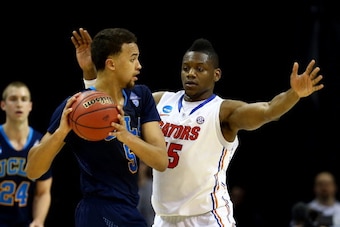 MEMPHIS, TN - MARCH 27: Will Yeguete #15 of the Florida Gators defends against Kyle Anderson #5 of the UCLA Bruins  during a regional semifinal of the 2014 NCAA Men's Basketball Tournament at the FedExForum on March 27, 2014 in Memphis, Tennessee.  (Photo