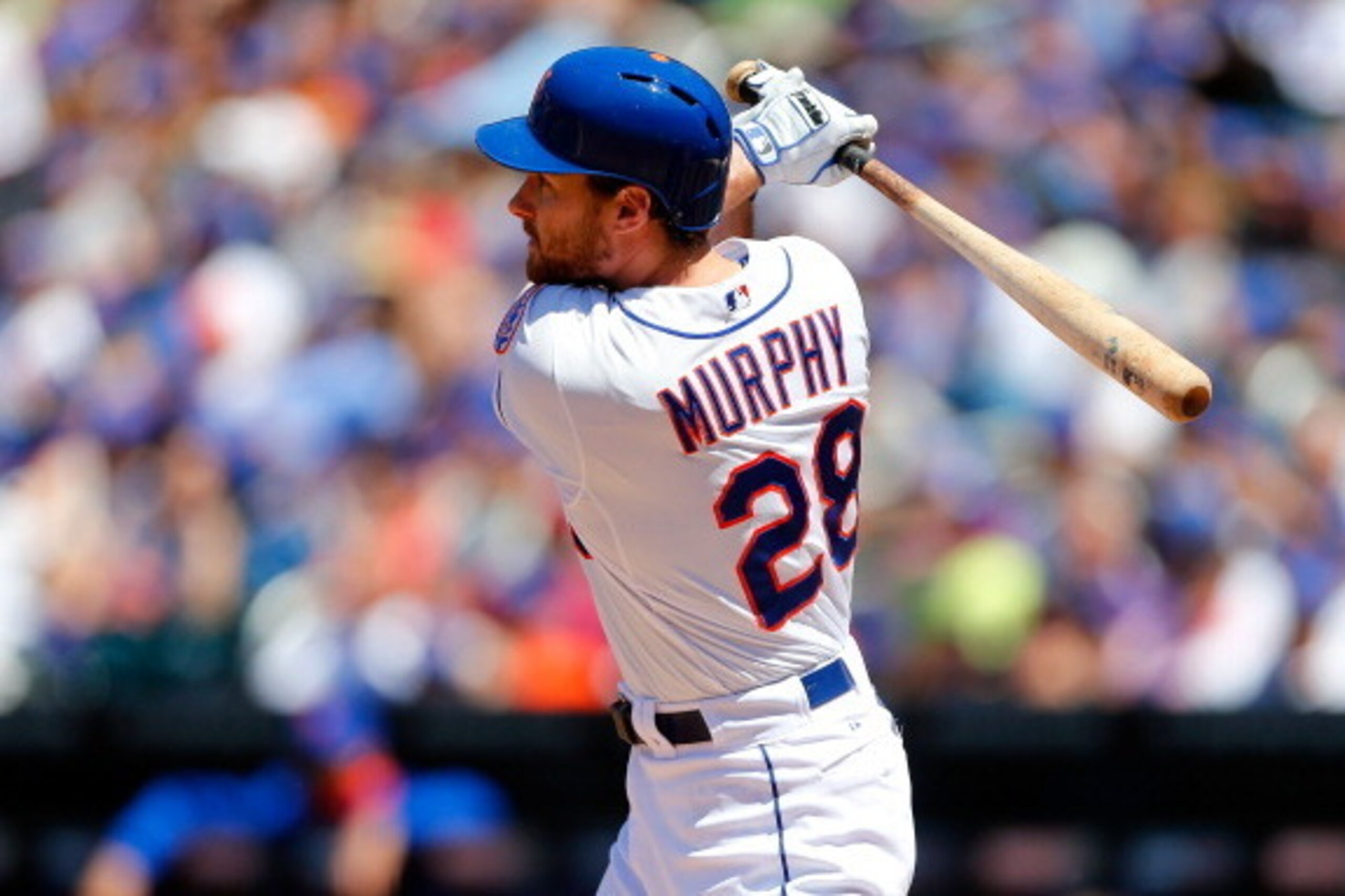 NEW YORK, NY - JUNE 15:  Daniel Murphy #28 of the New York Mets follows through on a second inning run scoring sacrifice fly against the San Diego Padres at Citi Field on June 15, 2014 in the Flushing neighborhood of the Queens borough of New York City.  