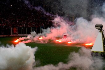 ROME, ITALY - MAY 03:  SSC Napoli fans throw flares before the TIM Cup final match between ACF Fiorentina and SSC Napoli at Olimpico Stadium on May 3, 2014 in Rome, Italy.  (Photo by Paolo Bruno/Getty Images)