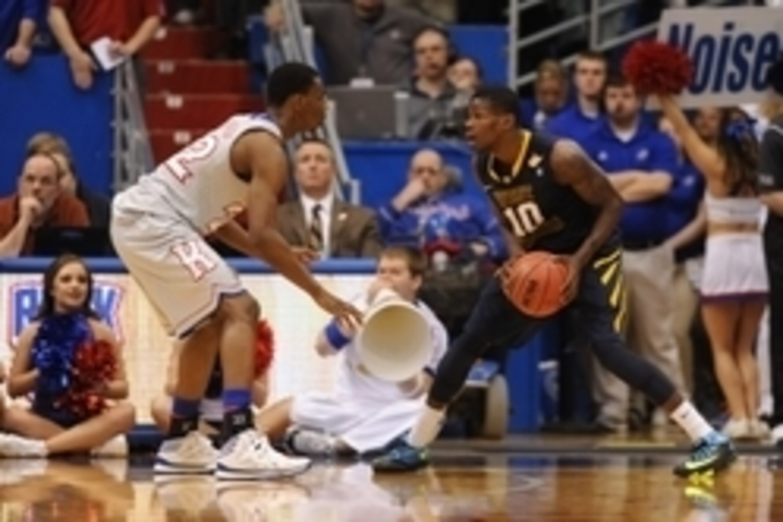 Feb 8, 2014; Lawrence, KS, USA; West Virginia Mountaineers guard Eron Harris (10) looks to pass as Kansas Jayhawks guard Andrew Wiggins (22) guards in the second half at Allen Fieldhouse. Kansas won 83 - 69. Mandatory Credit: Denny Medley-USA TODAY Sports