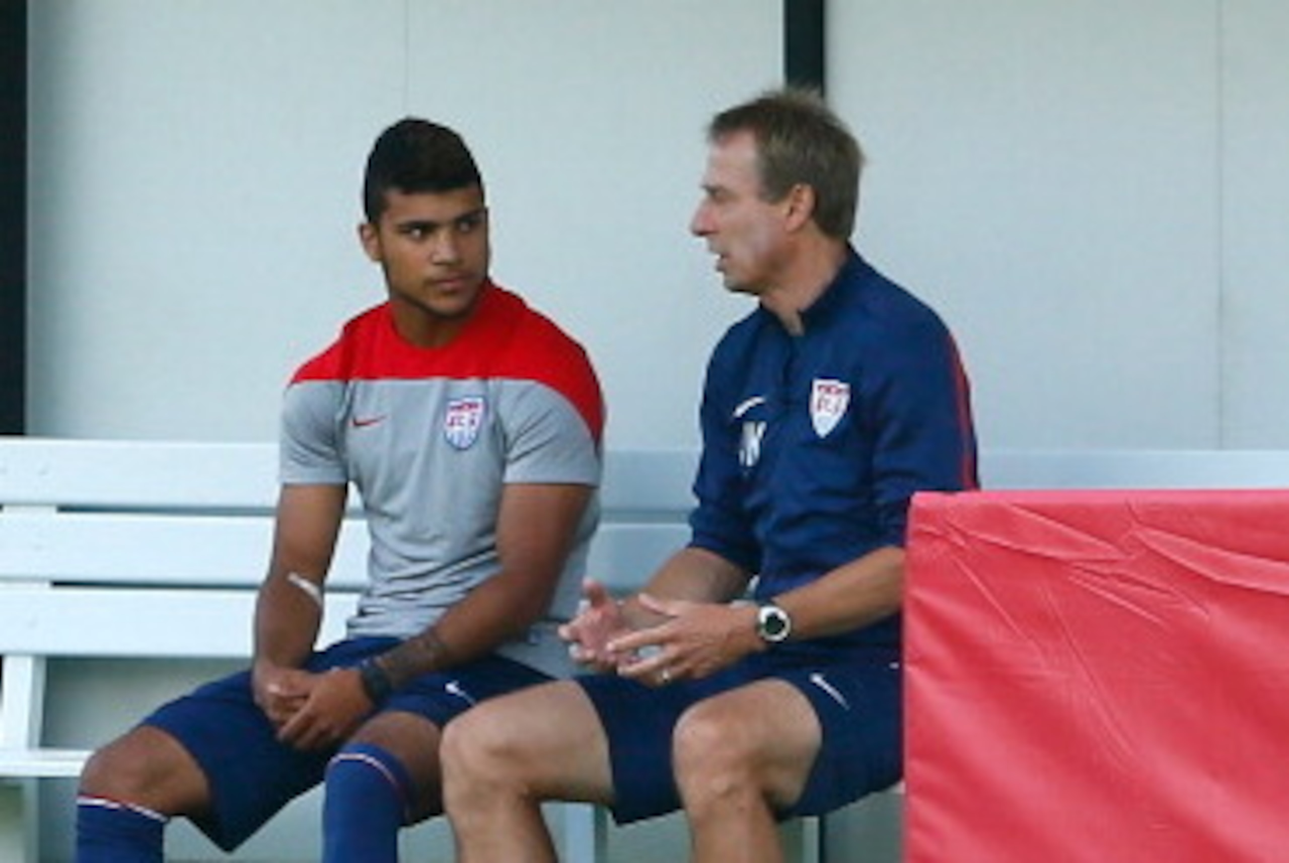 SAO PAULO, BRAZIL - JUNE 23:  Head coach Jurgen Klinsmann of the the United States speaks with DeAndre Yedlin prior to training at Sao Paulo FC on June 23, 2014 in Sao Paulo, Brazil.  (Photo by Kevin C. Cox/Getty Images)