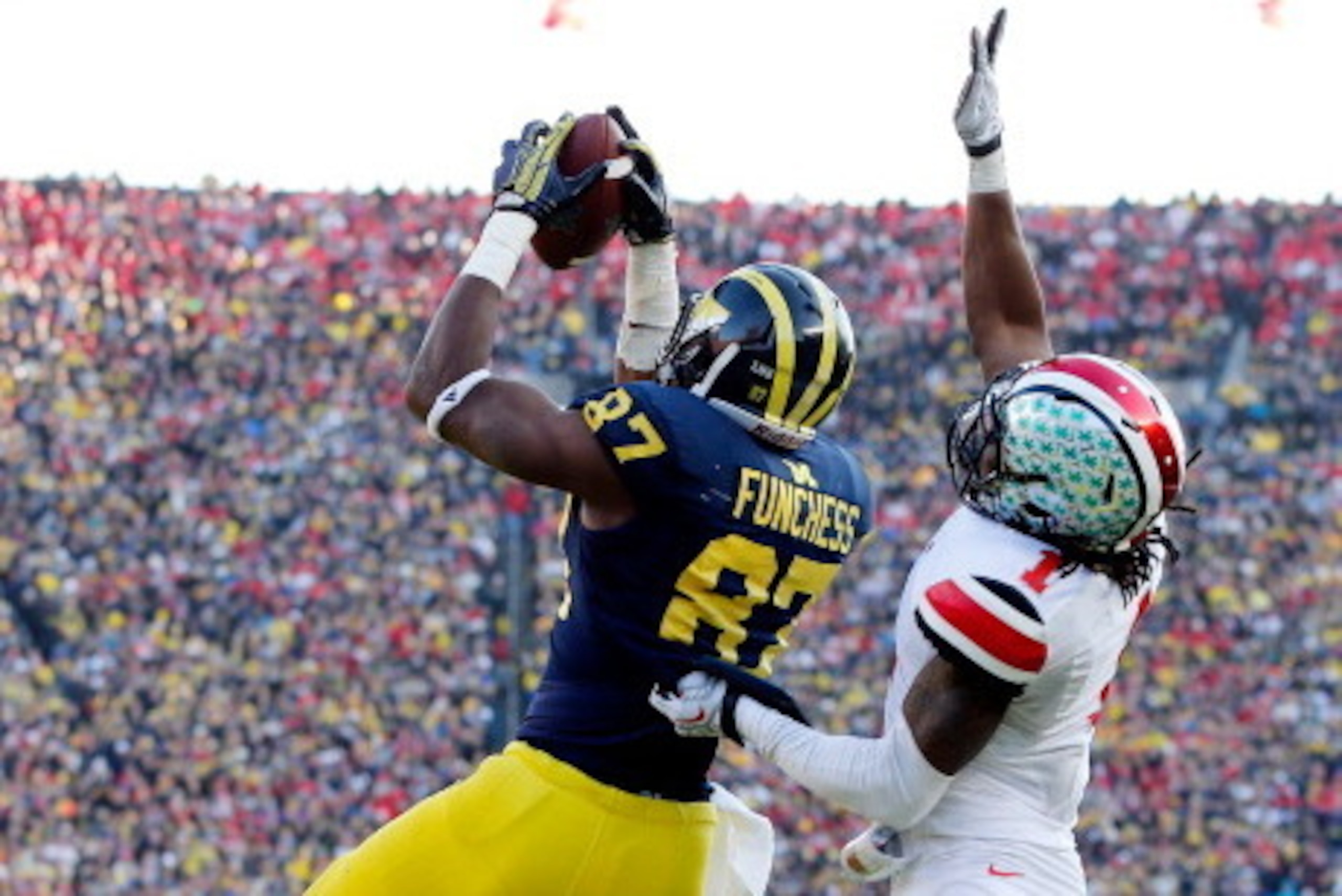 ANN ARBOR, MI - NOVEMBER 30:  Tight end Devin Funchess #87 of the Michigan Wolverines catches a fourth quarter touchdown as cornerback Bradley Roby #1 of the Ohio State Buckeyes defends during a game at Michigan Stadium on November 30, 2013 in Ann Arbor, 