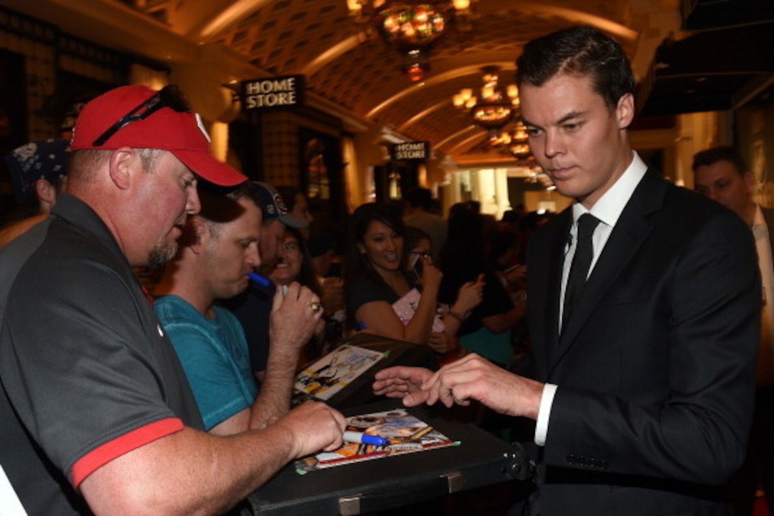 LAS VEGAS, NV - JUNE 24:  Jeff Thompson (L) of Canada gets an autograph from Tuukka Rask of the Boston Bruins as he arrives at the 2014 NHL Awards at Encore Las Vegas on June 24, 2014 in Las Vegas, Nevada.  (Photo by Ethan Miller/Getty Images)