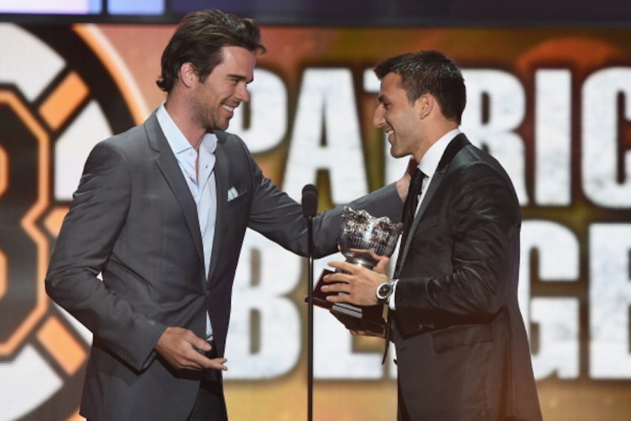 LAS VEGAS, NV - JUNE 24: Actor David Walton presents the Frank J. Selke Trophy to Patrice Bergeron of the Boston Bruins during the 2014 NHL Awards at the Encore Theater at Wynn Las Vegas on June 24, 2014 in Las Vegas, Nevada.  (Photo by Ethan Miller/Getty