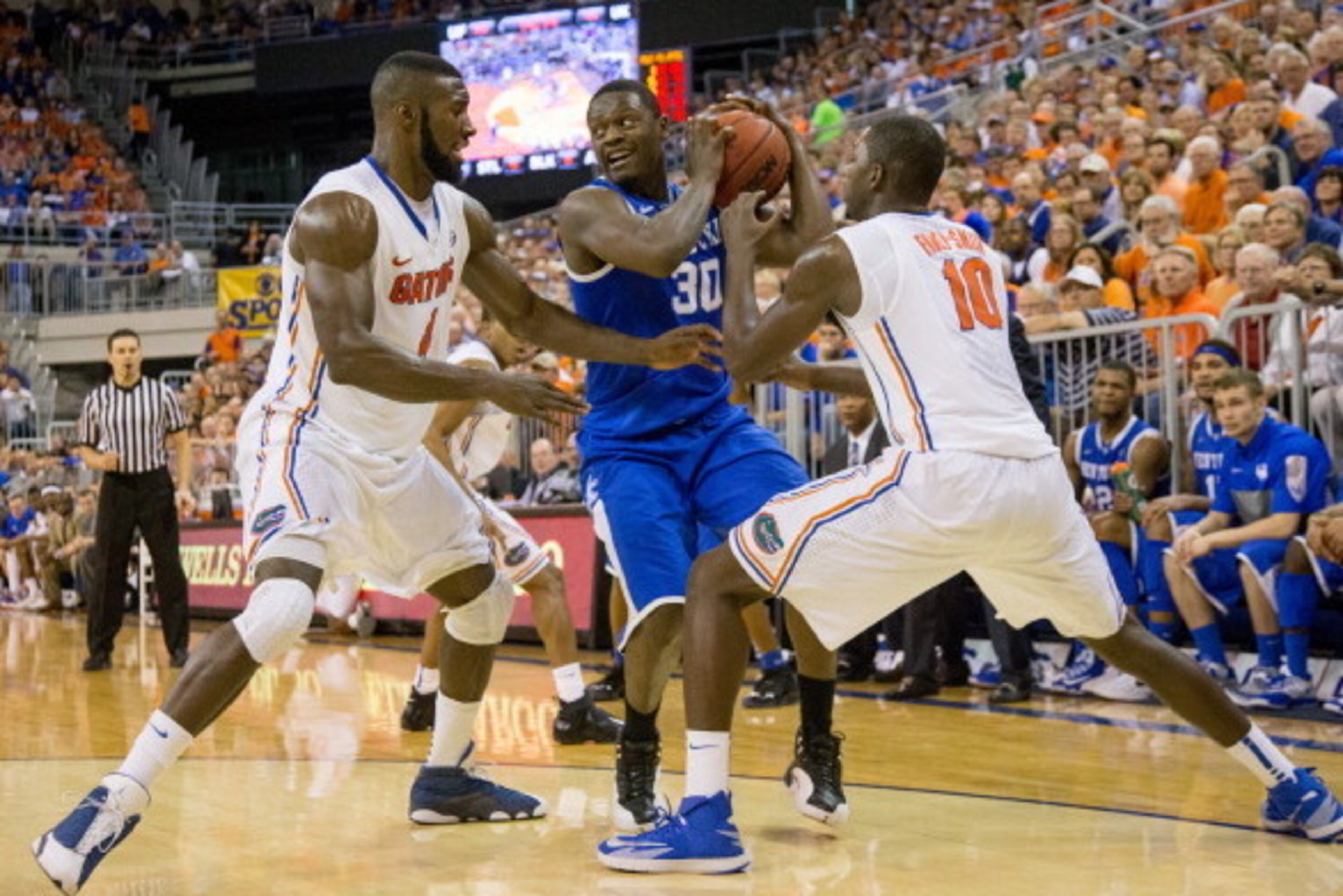GAINESVILLE, FL - MARCH 08: Julius Randle #30 of the Kentucky Wildcats is defended by Patric Young #4 and Dorian Finney-Smith #10 of the Florida Gators during the second half of the game at the Stephen C. O'Connell Center on March 8, 2014 in Gainesville, 