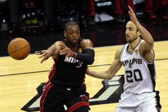 SAN ANTONIO, TX - JUNE 15: Dwyane Wade #3 of the Miami Heat makes a pass against Manu Ginobili #20 of the San Antonio Spurs during Game Five of the 2014 NBA Finals at the AT&T Center on June 15, 2014 in San Antonio, Texas. NOTE TO USER: User expressly ack