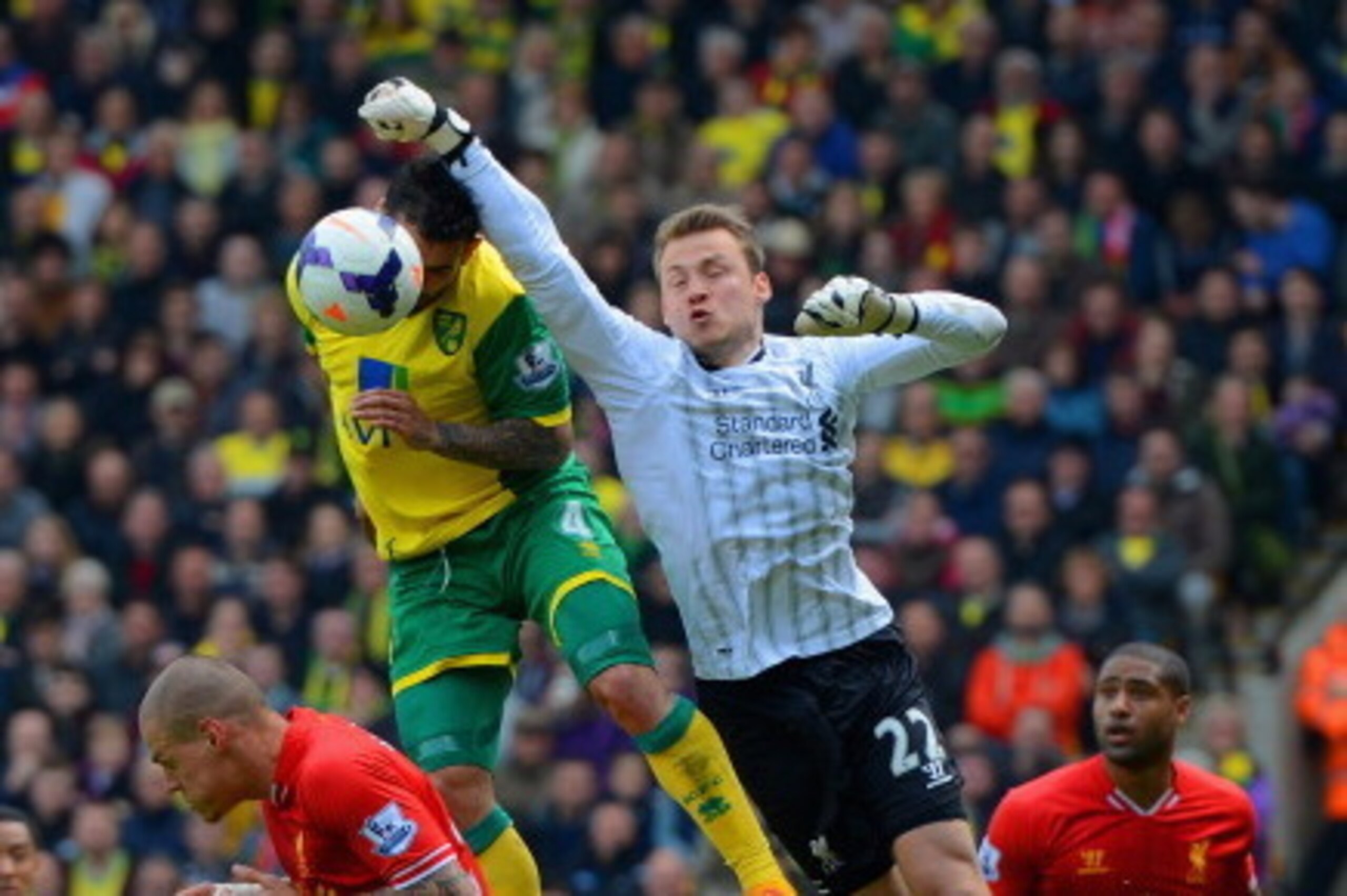 NORWICH, ENGLAND - APRIL 20:  Simon Mignolet of Liverpool fails to punch the ball clear during the Barclays Premier League match between Norwich City and Liverpool at Carrow Road on April 20, 2014 in Norwich, England.  (Photo by Michael Regan/Getty Images