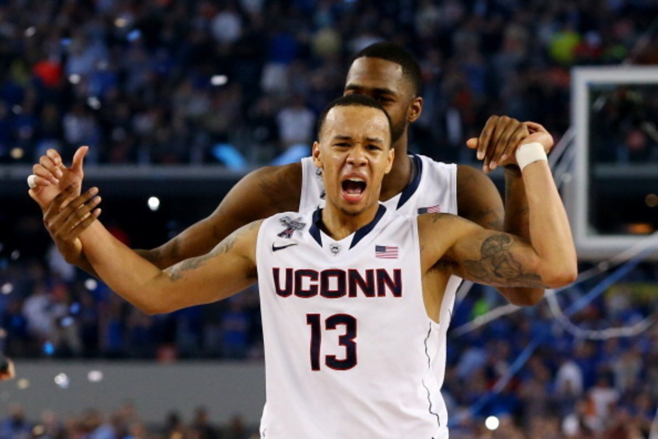 ARLINGTON, TX - APRIL 07:  Shabazz Napier #13 of the Connecticut Huskies celebrates on the court after defeating the Kentucky Wildcats 60-54 in the NCAA Men's Final Four Championship at AT&T Stadium on April 7, 2014 in Arlington, Texas.  (Photo by Ronald 
