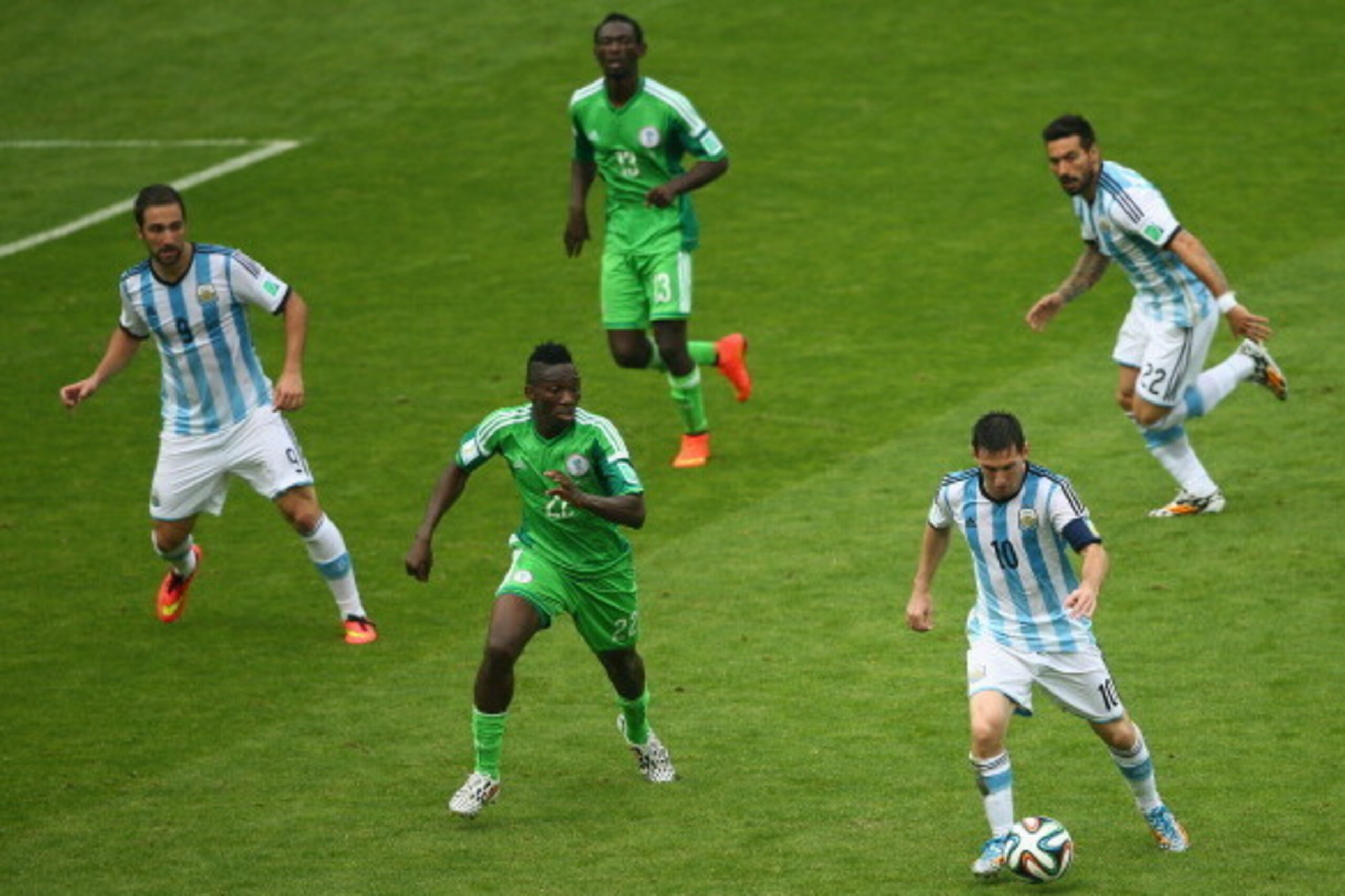 PORTO ALEGRE, BRAZIL - JUNE 25: Lionel Messi of Argentina controls the ball against Kenneth Omeruo of Nigeria during the 2014 FIFA World Cup Brazil Group F match between Nigeria and Argentina at Estadio Beira-Rio on June 25, 2014 in Porto Alegre, Brazil.