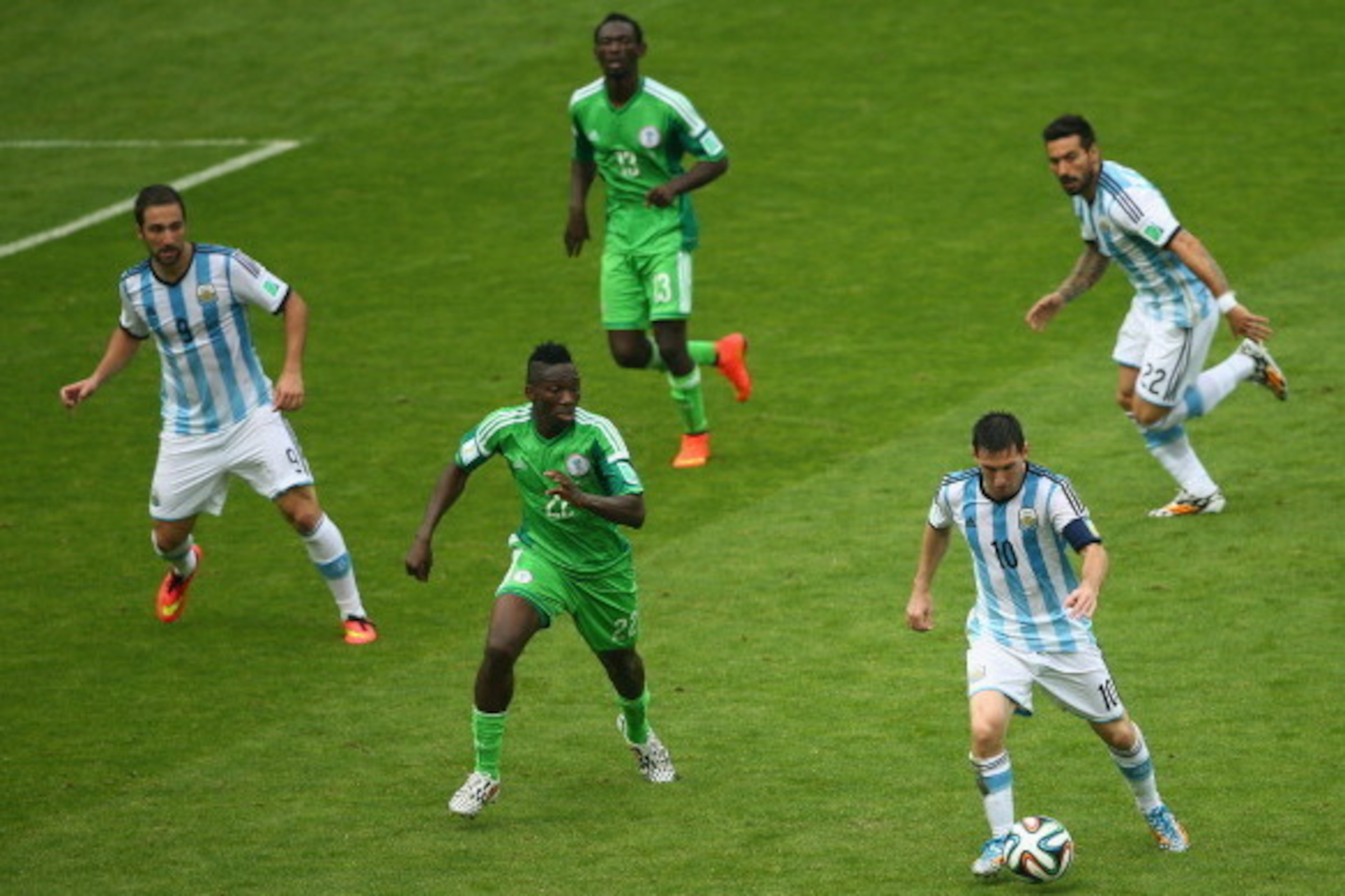 PORTO ALEGRE, BRAZIL - JUNE 25: Lionel Messi of Argentina controls the ball against Kenneth Omeruo of Nigeria during the 2014 FIFA World Cup Brazil Group F match between Nigeria and Argentina at Estadio Beira-Rio on June 25, 2014 in Porto Alegre, Brazil.