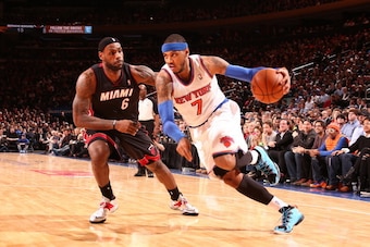 NEW YORK, NY - JANUARY 9: Carmelo Anthony #7 of the New York Knicks drives against LeBron James #6 of the Miami Heat during a game at Madison Square Garden in New York City on January 9, 2014.  NOTE TO USER: User expressly acknowledges and agrees that, by