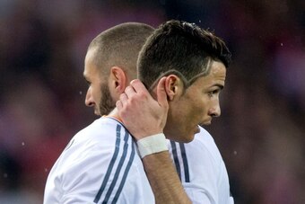 MADRID, SPAIN - MARCH 02:  Karim Benzema (2ndR) embraces his teammate Cristiano Ronaldo (R) during the La Liga match between Club Atletico de Madrid and Real Madrid CF at Vicente Calderon Stadium on March 2, 2014 in Madrid, Spain.  (Photo by Gonzalo Arroy