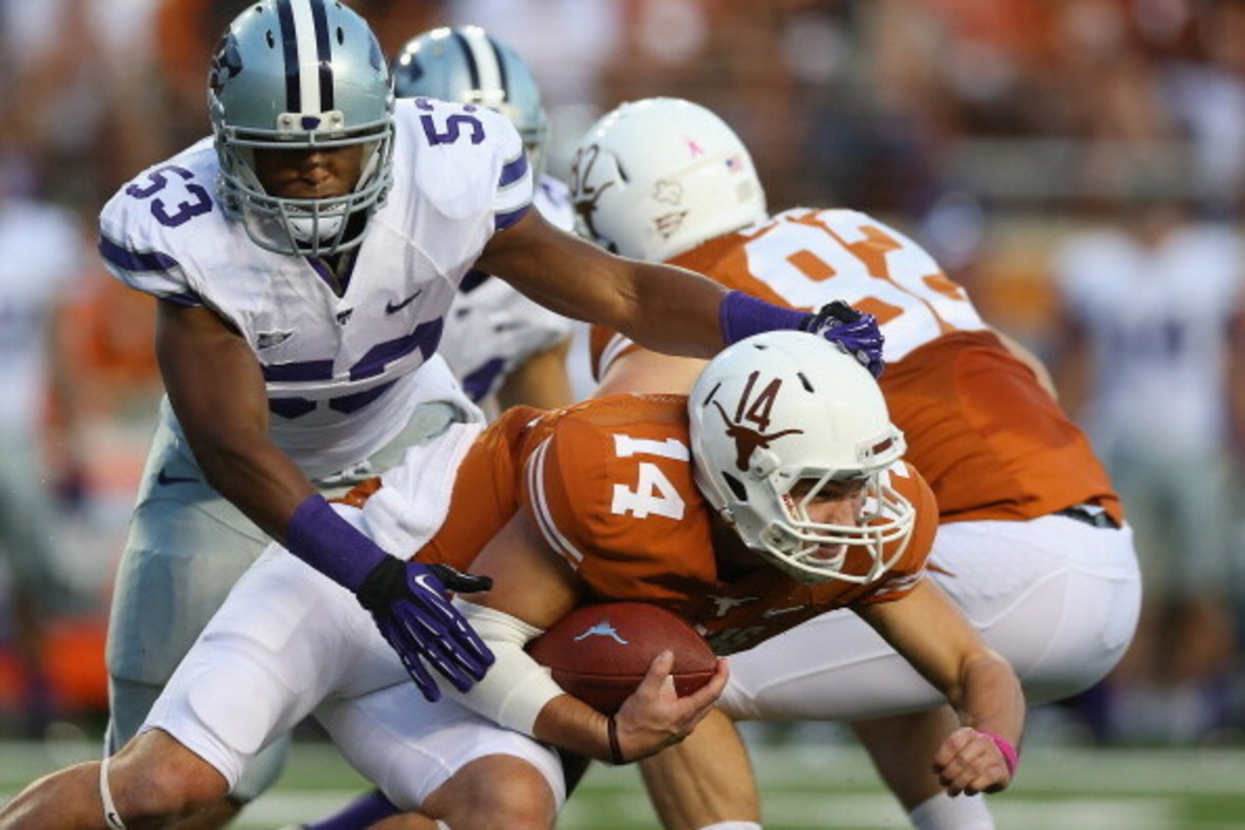 AUSTIN, TX - SEPTEMBER 21:  David Ash #14 of the Texas Longhorns is tackled by Blake Slaughter #53 of the Kansas State Wildcats at Darrell K Royal-Texas Memorial Stadium on September 21, 2013 in Austin, Texas.  (Photo by Ronald Martinez/Getty Images)