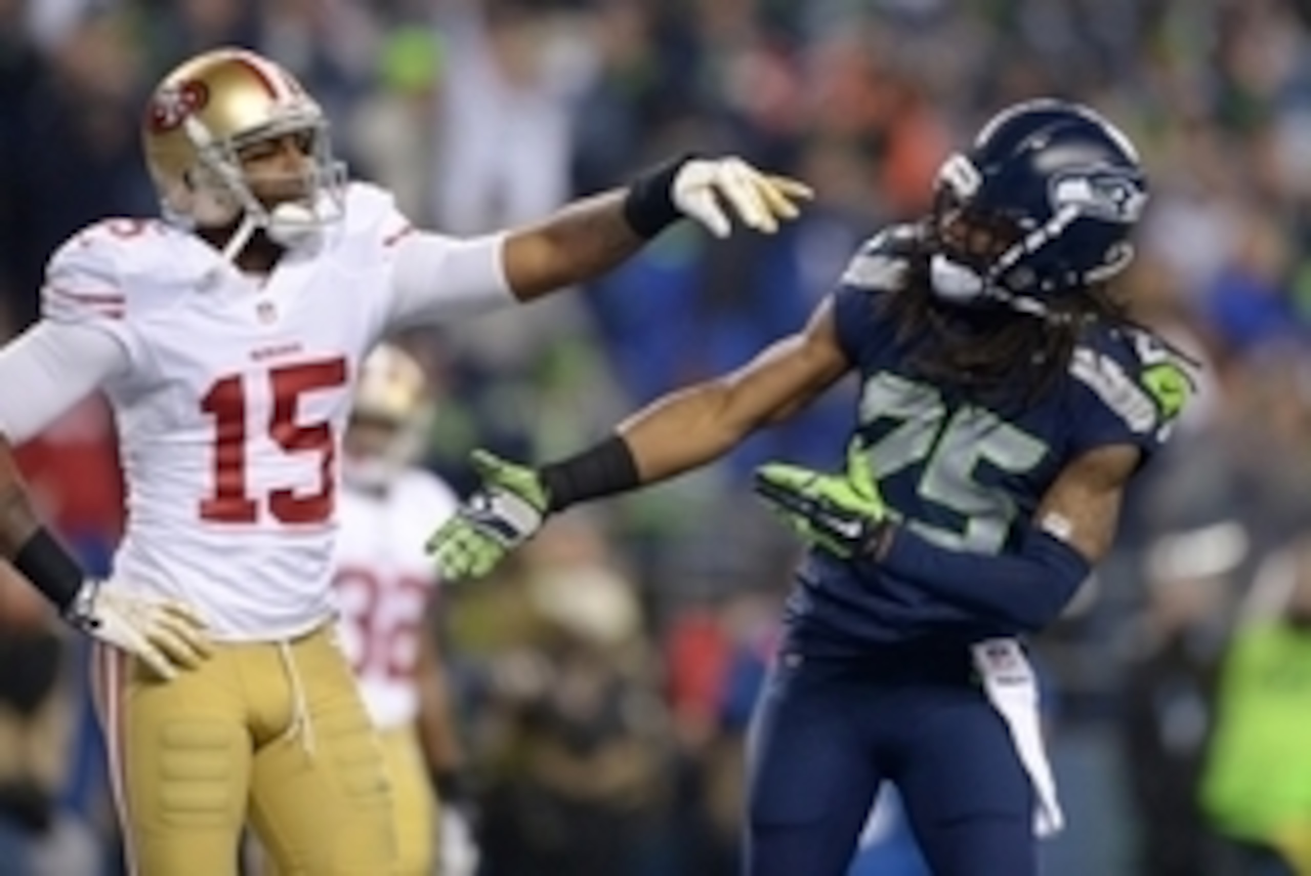 Jan 19, 2014; Seattle, WA, USA; Seattle Seahawks cornerback Richard Sherman (25) is shoved by San Francisco 49ers wide receiver Michael Crabtree (15) while trying to shake hands after an interception by Seahawks outside linebacker Malcolm Smith (not pictu