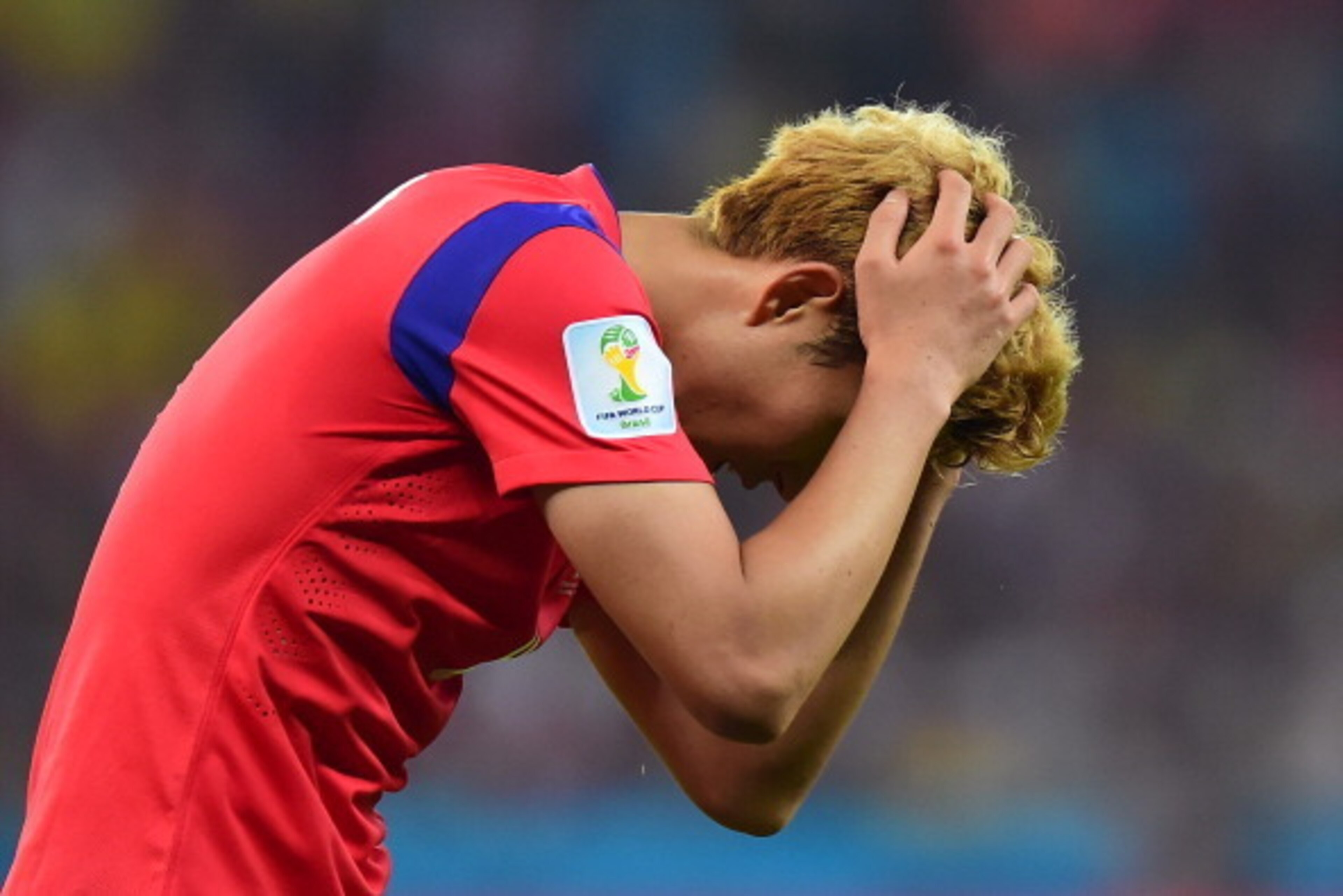 PORTO ALEGRE, BRAZIL - JUNE 22:  A dejected Son Heung-Min of South Korea walks off the pitch afte a 4-2 defeat in the 2014 FIFA World Cup Brazil Group H match between South Korea and Algeria at Estadio Beira-Rio on June 22, 2014 in Porto Alegre, Brazil.  