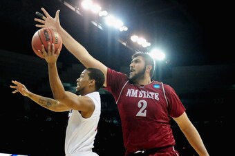 SPOKANE, WA - MARCH 20:  Sim Bhullar #2 of the New Mexico State Aggies tries to block Aqeel Quinn #10 of the San Diego State Aztecs during the second round of the 2014 NCAA Men's Basketball Tournament at Spokane Veterans Memorial Arena on March 20, 2014 i