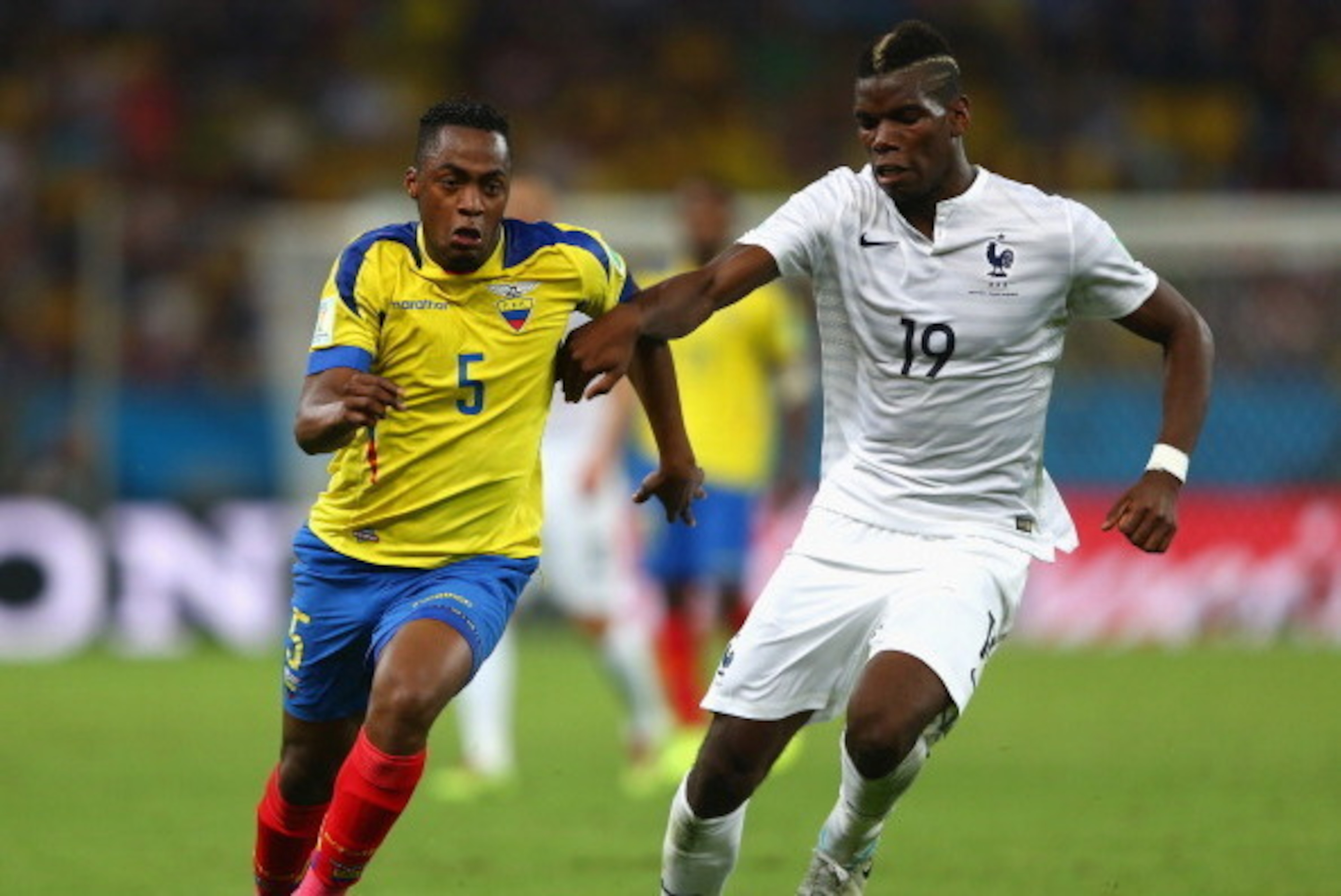RIO DE JANEIRO, BRAZIL - JUNE 25: Alex Ibarra of Ecuador is challenged by Paul Pogba of France during the 2014 FIFA World Cup Brazil Group E match between Ecuador and France at Maracana on June 25, 2014 in Rio de Janeiro, Brazil.  (Photo by Jamie Squire/G