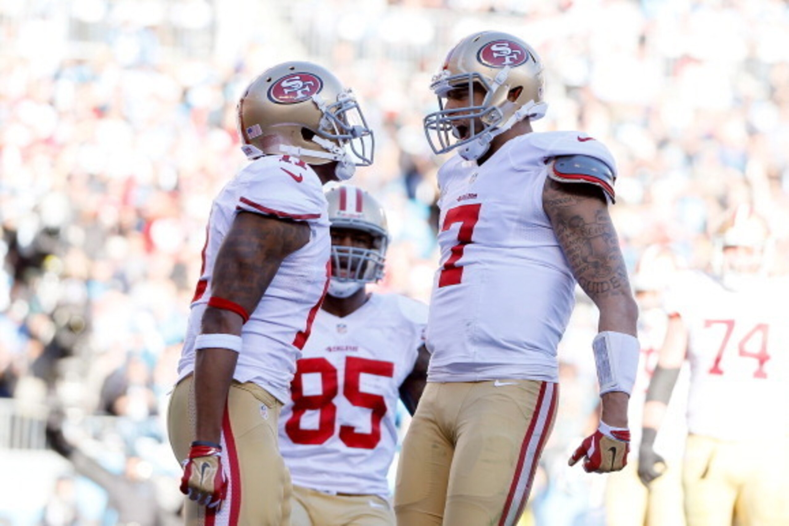 CHARLOTTE, NC - JANUARY 12:  Colin Kaepernick #7 of the San Francisco 49ers celebrates with Quinton Patton #11 after a touchdown in the third quarter against the Carolina Panthers during the NFC Divisional Playoff Game at Bank of America Stadium on Januar