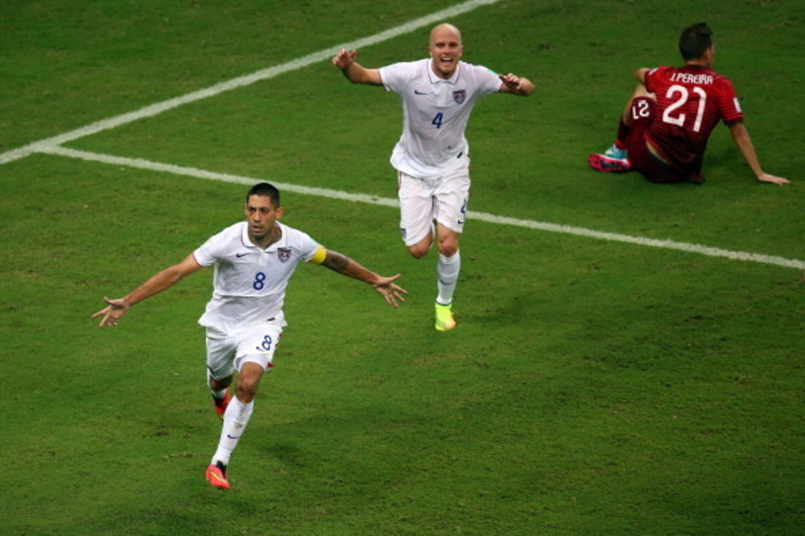 MANAUS, BRAZIL - JUNE 22: Clint Dempsey of the United States celebrates scoring his team's second goal with teammate Michael Bradley as Joao Pereira of Portugal looks on during the 2014 FIFA World Cup Brazil Group G match between the United States and Por