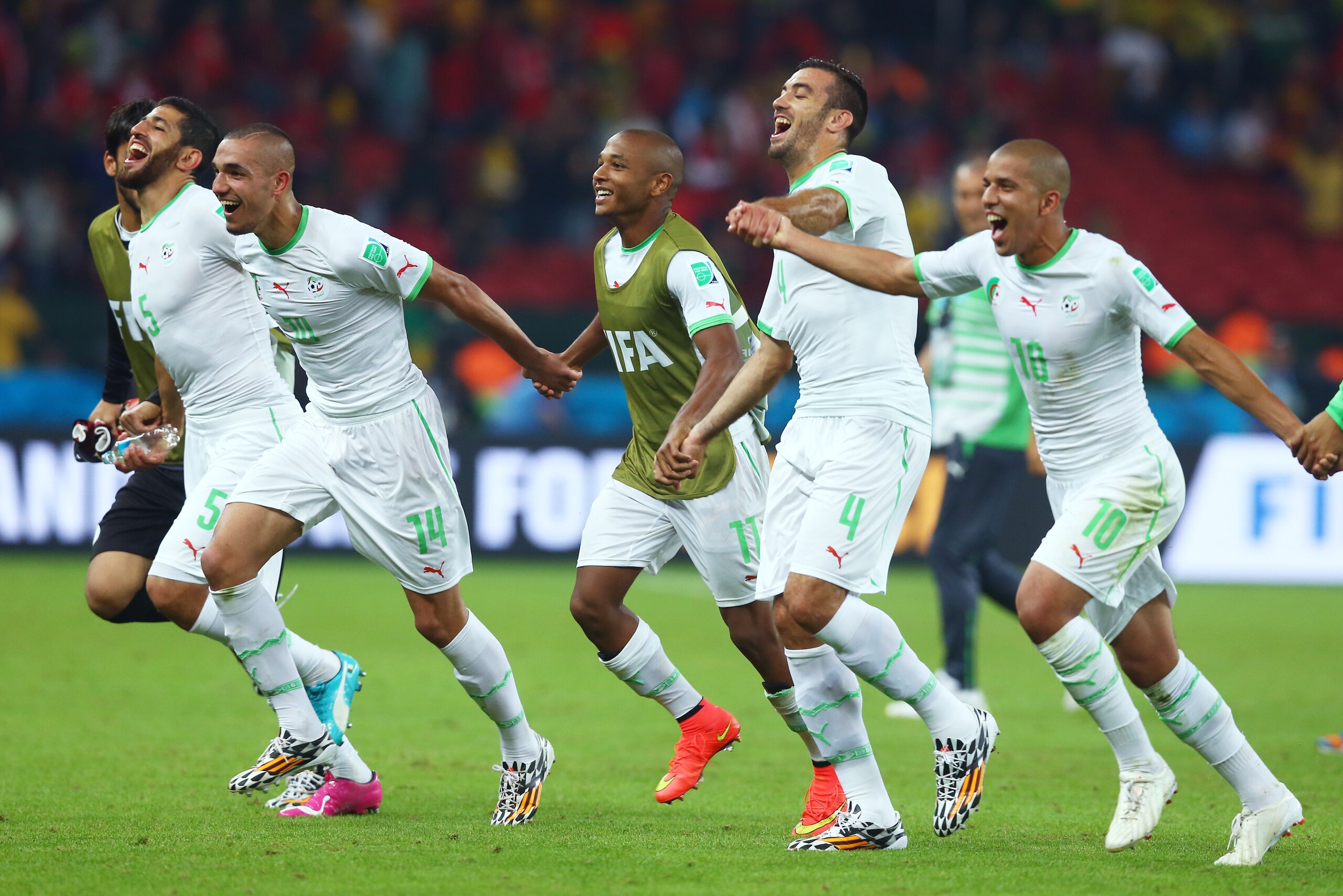 PORTO ALEGRE, BRAZIL - JUNE 22:  Algeria celebrate after defeating South Korea 4-2 during the 2014 FIFA World Cup Brazil Group H match between South Korea and Algeria at Estadio Beira-Rio on June 22, 2014 in Porto Alegre, Brazil.  (Photo by Jeff Gross/Get