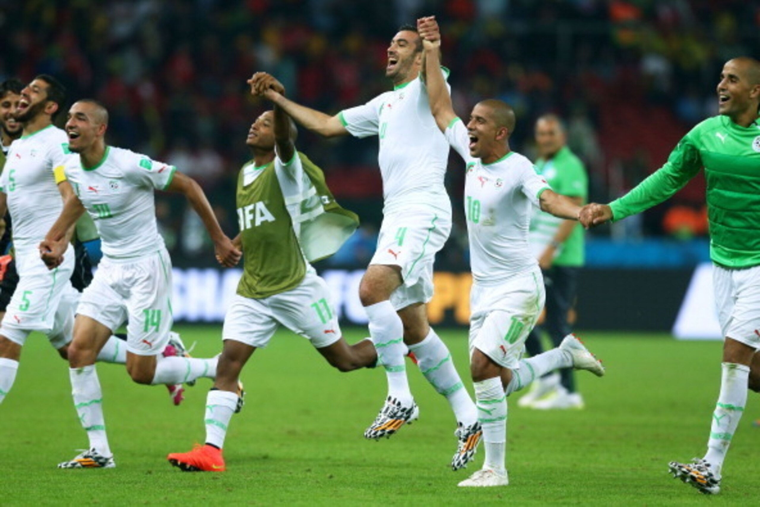 PORTO ALEGRE, BRAZIL - JUNE 22:  Algeria celebrate after defeating South Korea 4-2 during the 2014 FIFA World Cup Brazil Group H match between South Korea and Algeria at Estadio Beira-Rio on June 22, 2014 in Porto Alegre, Brazil.  (Photo by Jeff Gross/Get