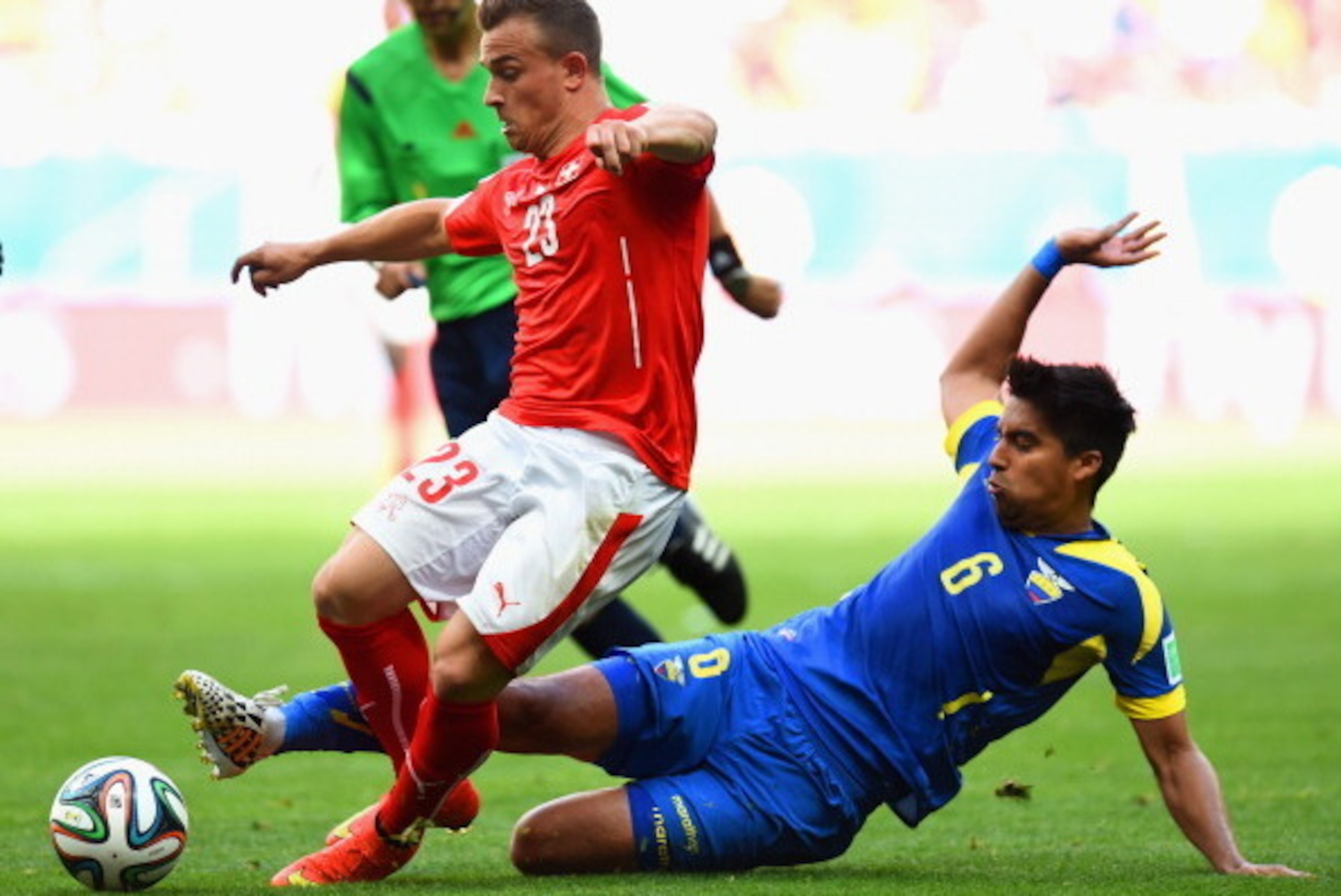 BRASILIA, BRAZIL - JUNE 15: Christian Noboa of Ecuador tackles Xherdan Shaqiri of Switzerland during the 2014 FIFA World Cup Brazil Group E match between Switzerland and Ecuador at Estadio Nacional on June 15, 2014 in Brasilia, Brazil.  (Photo by Stu Fors