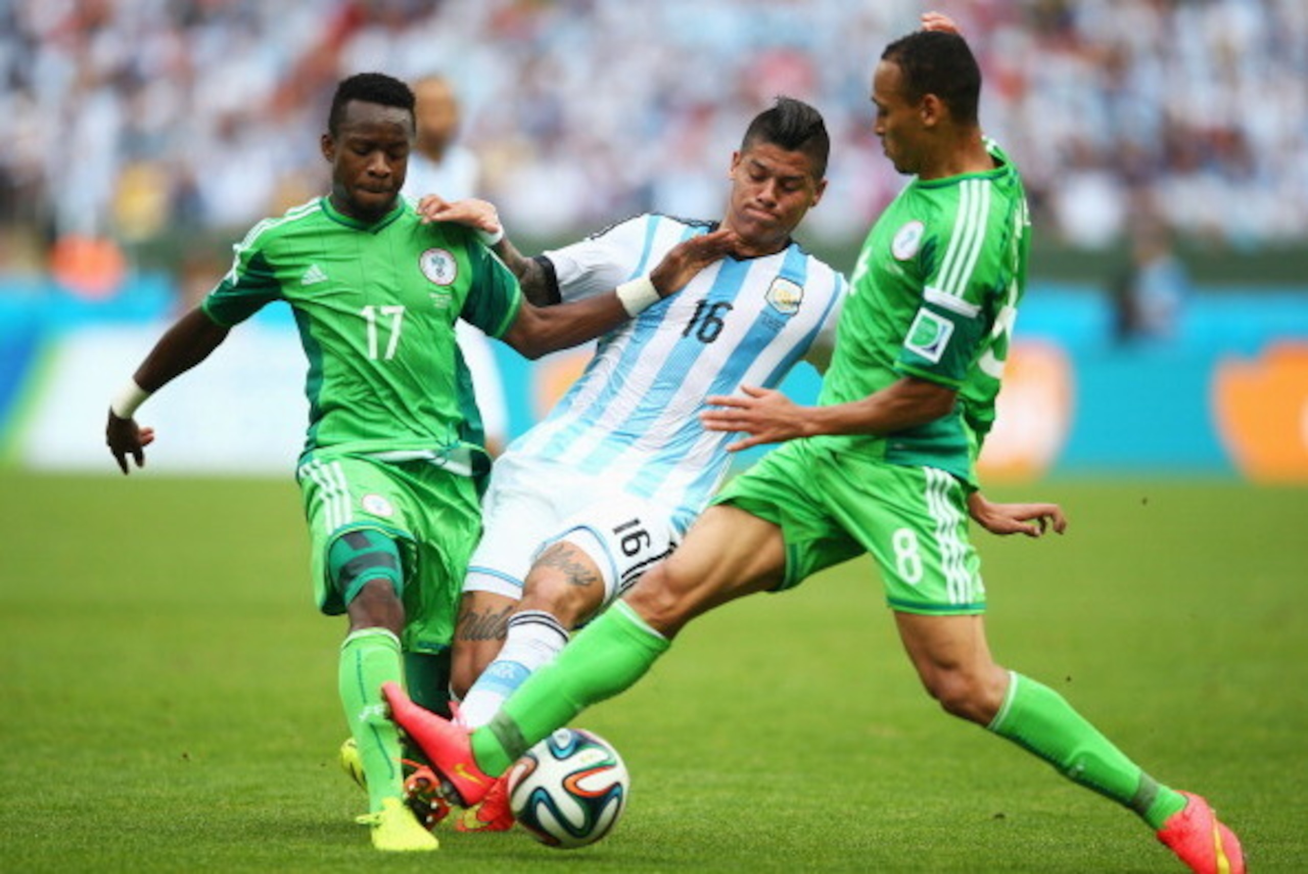PORTO ALEGRE, BRAZIL - JUNE 25: Marcos Rojo of Argentina is challenged by Ogenyi Onazi (L) and Peter Odemwingie of Nigeria during the 2014 FIFA World Cup Brazil Group F match between Nigeria and Argentina at Estadio Beira-Rio on June 25, 2014 in Porto Ale