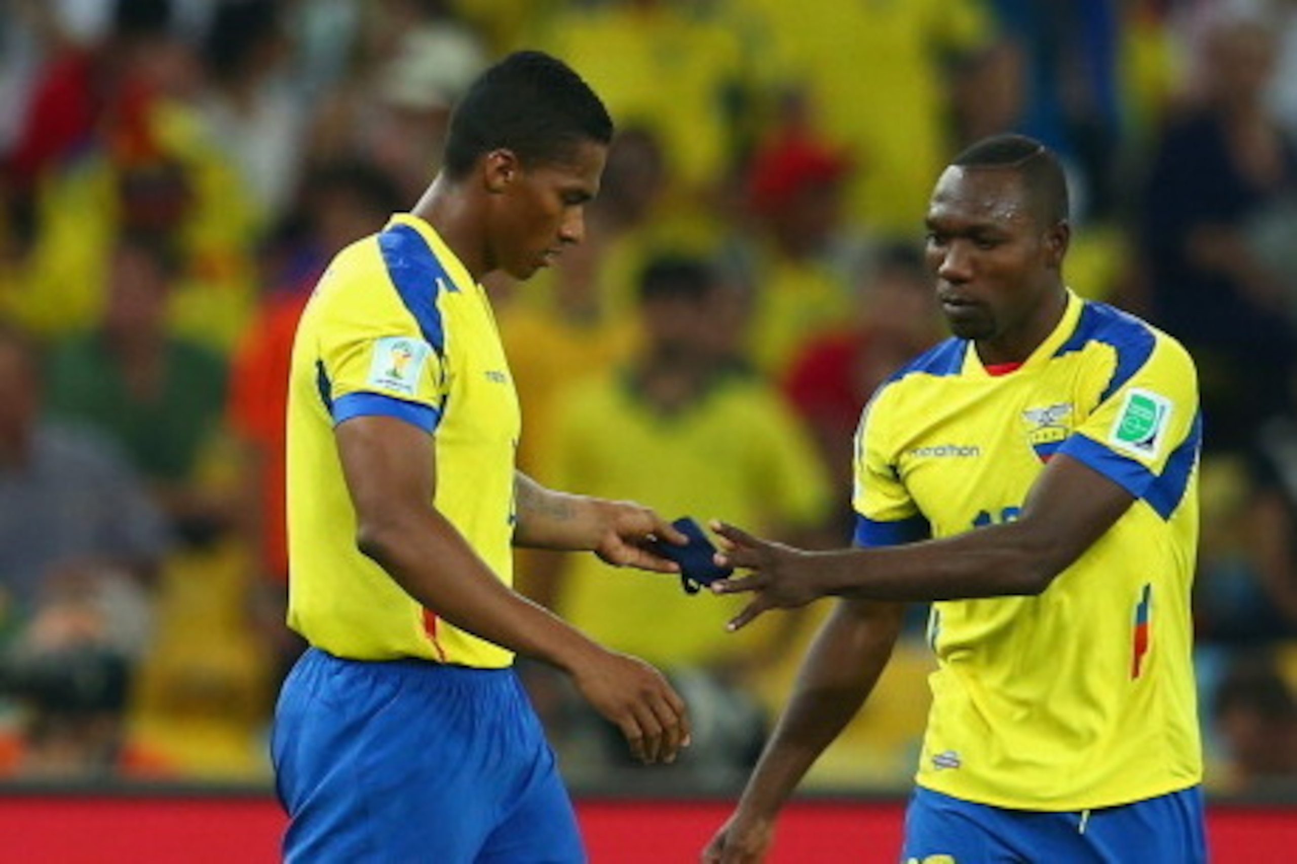 RIO DE JANEIRO, BRAZIL - JUNE 25: Antonio Valencia of Ecuador hands the captain's armband to Walter Ayovi after being sent off with a red card during the 2014 FIFA World Cup Brazil Group E match between Ecuador and France at Maracana on June 25, 2014 in R