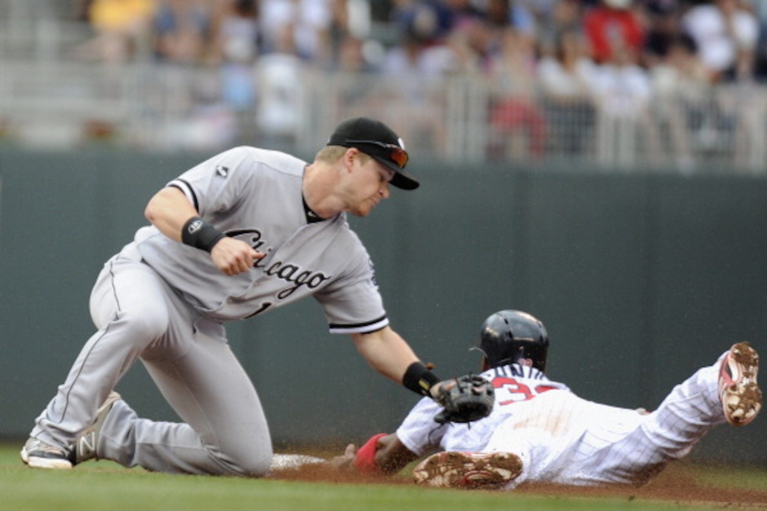 MINNEAPOLIS, MN - JUNE 22: Gordon Beckham #15 of the Chicago White Sox tags out Danny Santana #39 of the Minnesota Twins stealing second base during the sixth inning of the game on June 22, 2014 at Target Field in Minneapolis, Minnesota. The Twins defeate