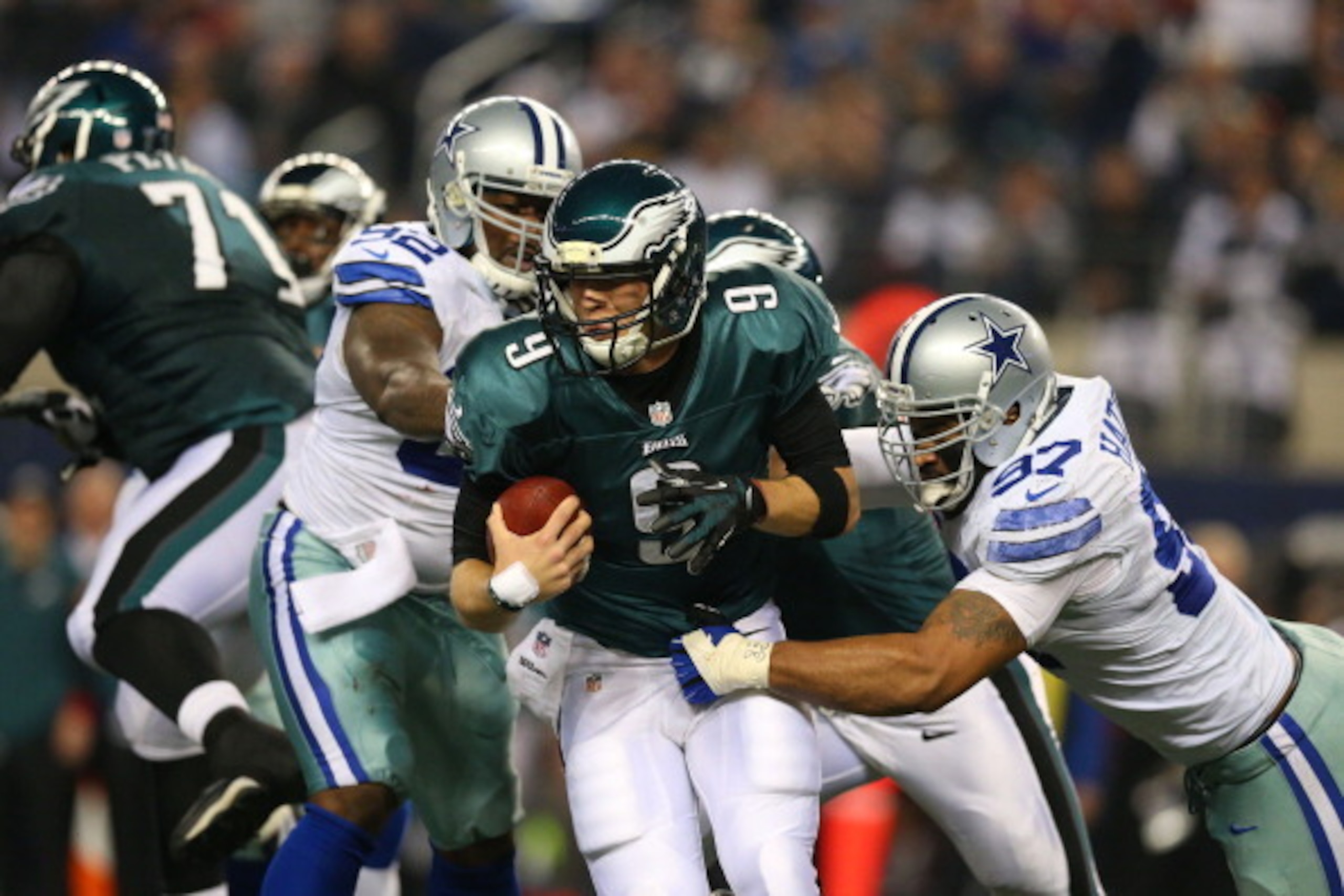 ARLINGTON, TX - DECEMBER 29:  Nick Foles #9 of the Philadelphia Eagles tries to break the tackle of Jason Hatcher #97 of the Dallas Cowboys in the first half at Cowboys Stadium on December 29, 2013 in Arlington, Texas.  (Photo by Ronald Martinez/Getty Ima